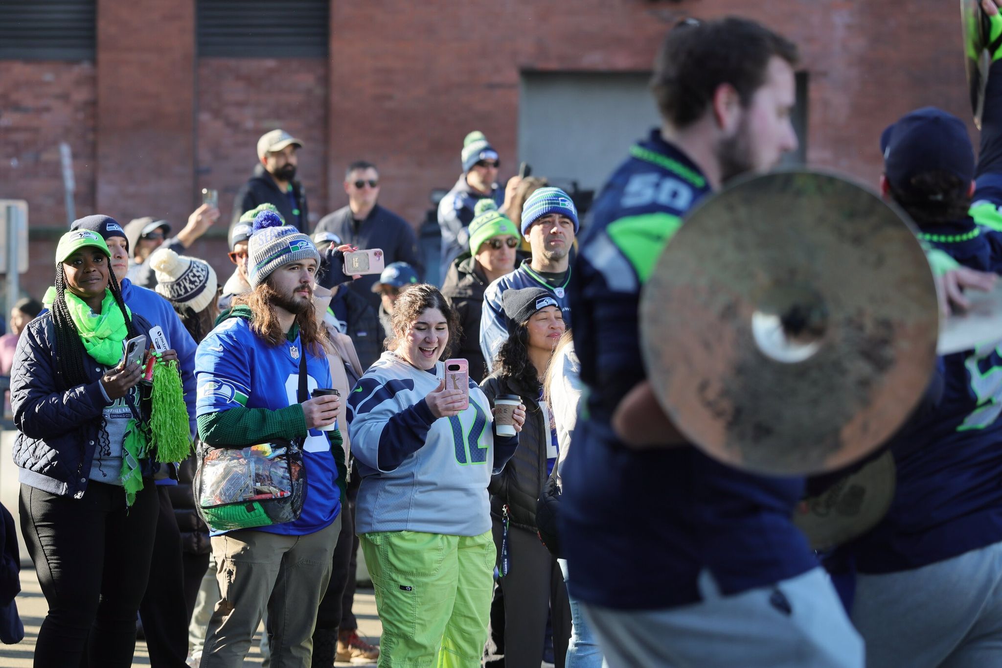 The ‘12s’ watched Blue Thunder perform outside Lumen Field before the NFC championship game on Sunday afternoon in Seattle, Wash., Jan. 25, 2026. (Kevin Clark / The Seattle Times)