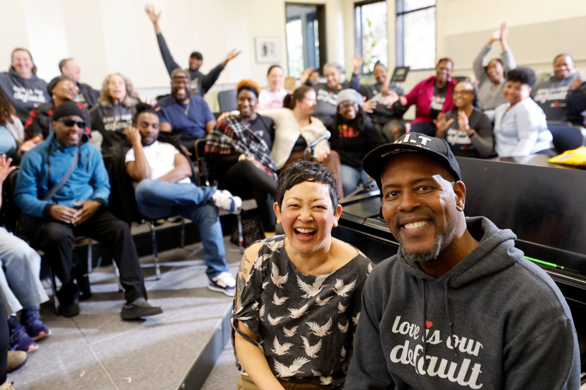 Co-founders and co-executive directors Cindy Ogasawara, president (center), and Marshawn Moultrie, artistic director (right), with members of Resounding Love, a multiracial, interfaith, LGBTQ+-welcoming choir, during rehearsal at South Seattle College on Saturday. The racially diverse choir believes in 'radical inclusion and social connection through music.' (Karen Ducey / The Seattle Times)