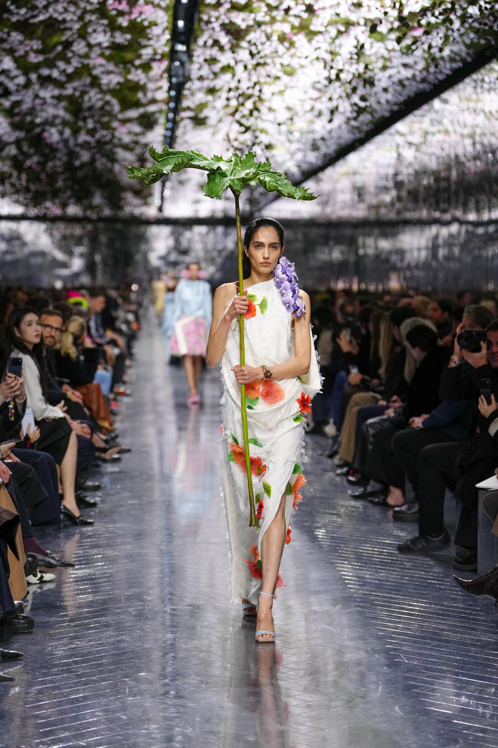 Pondering a parasol at the Christian Dior fashion show | The