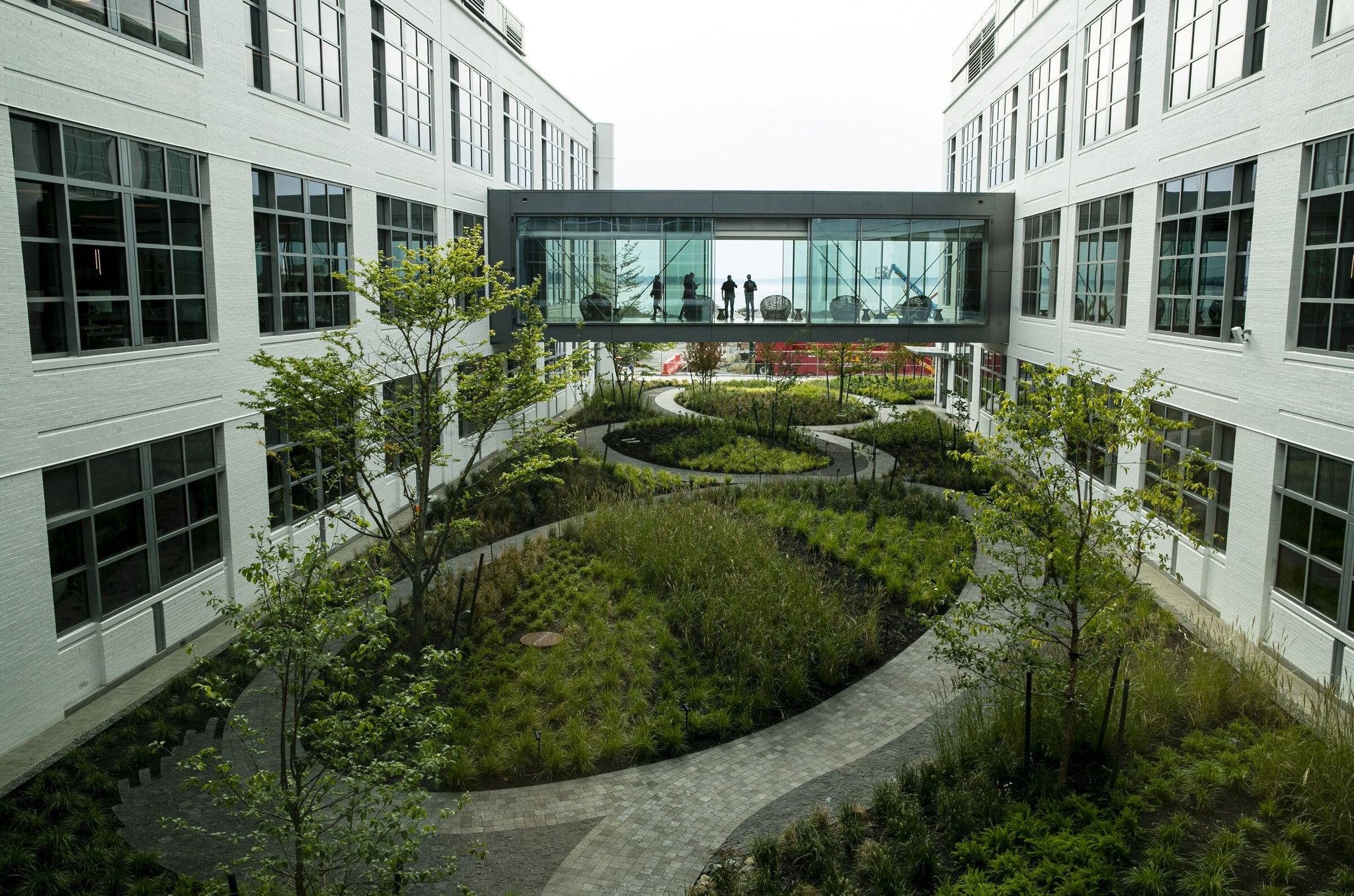 People walk the Expedia campus on Elliott Bay in Seattle in 2019. The company announced Wednesday it will lay off 162 Washington-state employees in April. (Erica Schultz / The Seattle Times)