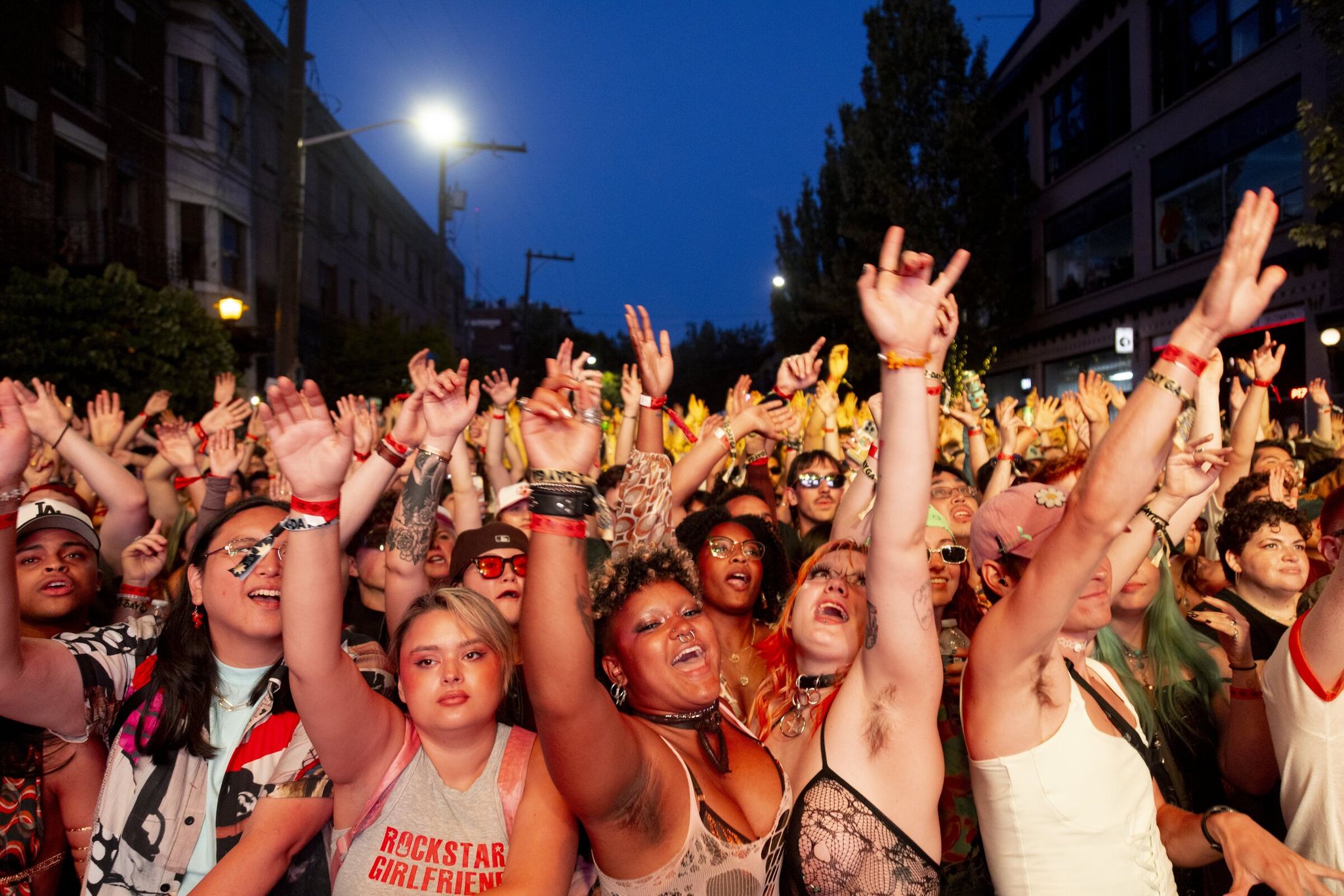 A crowd dances with raised hands as DJ P-W performs on the second day of Capitol Hill Block Party. The state of Washington surpassed a demographic milestone according to the U.S. Census Bureau: as of July 1, 2025, the state had more than 8 million residents for the first time. (Akash Pamarthy / The Seattle Times, 2025)