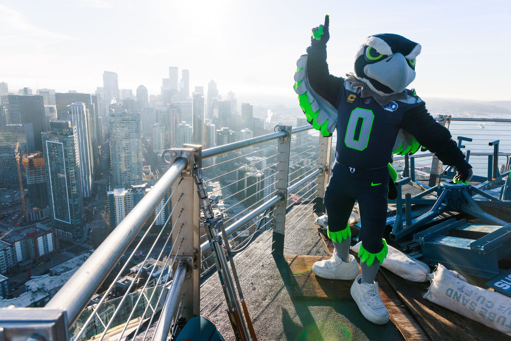 Blitz, the Seattle Seahawks’ mascot, raised the 12th Man flag above the Space Needle earlier this month. On Friday, Jan. 30, the Seahawks will celebrate their upcoming trip to the Super Bowl with a drone show at Seattle Center in the airspace near the Space Needle. (Erika Schultz / The Seattle Times)