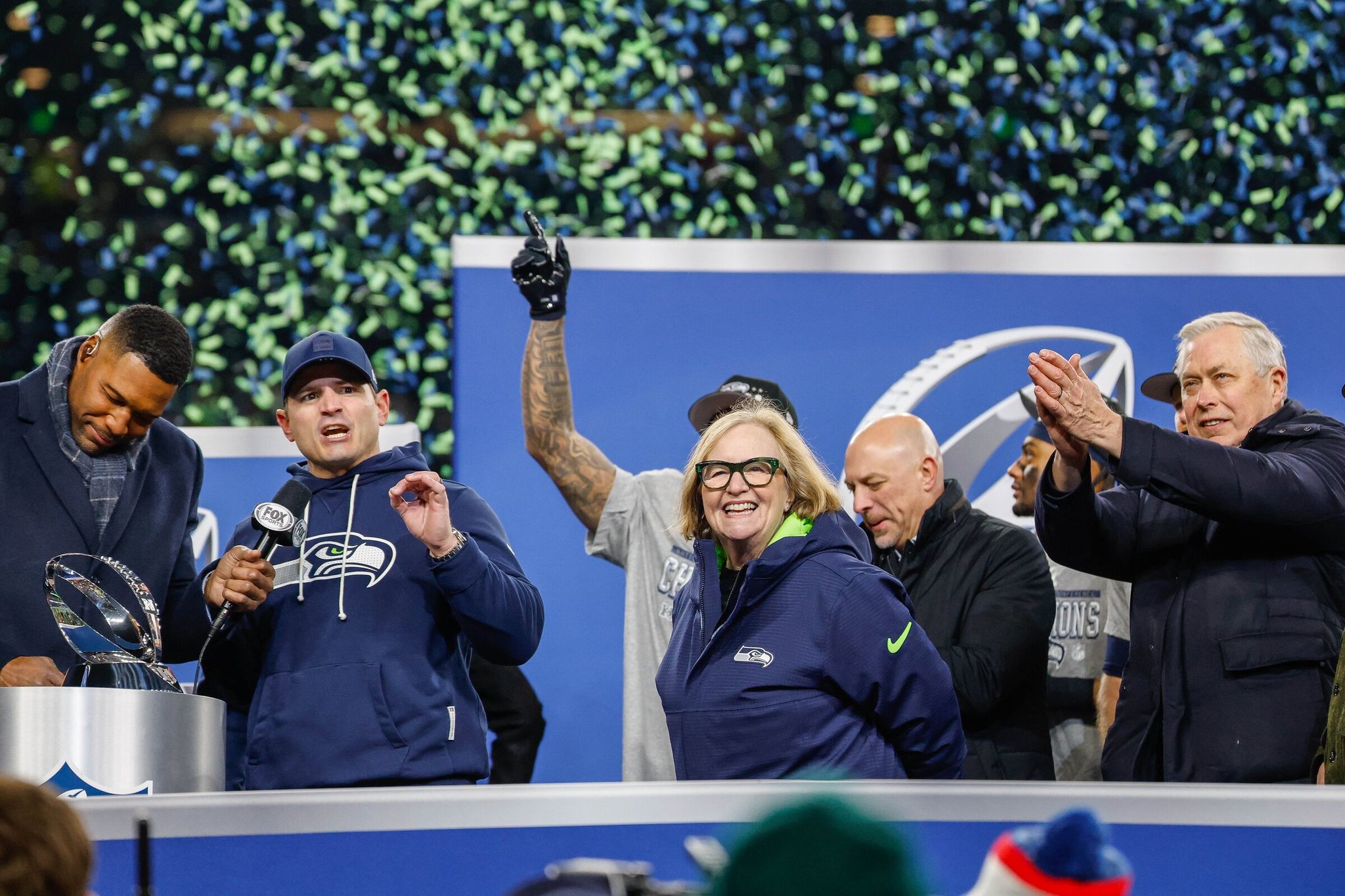 Seahawks coach Mike Macdonald with a microphone and team chair Jody Allen celebrate after winning the NFC championship on Sunday. On Friday reports surfaced that the team would be sold after the Super Bowl, but the Seahawks’ owners have denied this. (Dean Rutz / The Seattle Times)
