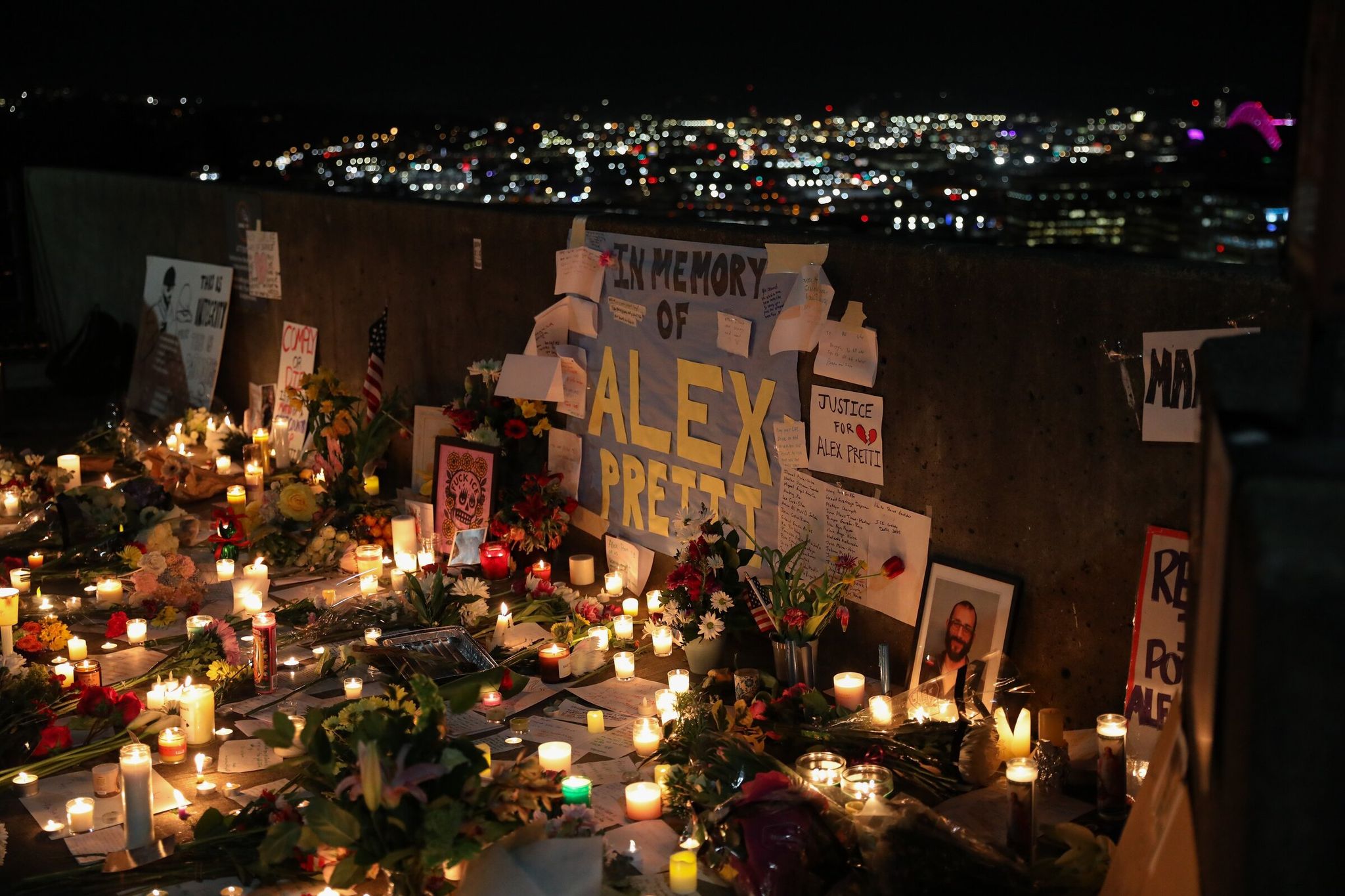 People placed candles and signs Jan. 26 at Harborview Medical Center in honor of Alex Pratte, an ICU nurse killed by Border Patrol agents in Minneapolis on Jan. 24. (Naomi Ishisaka / The Seattle Times)