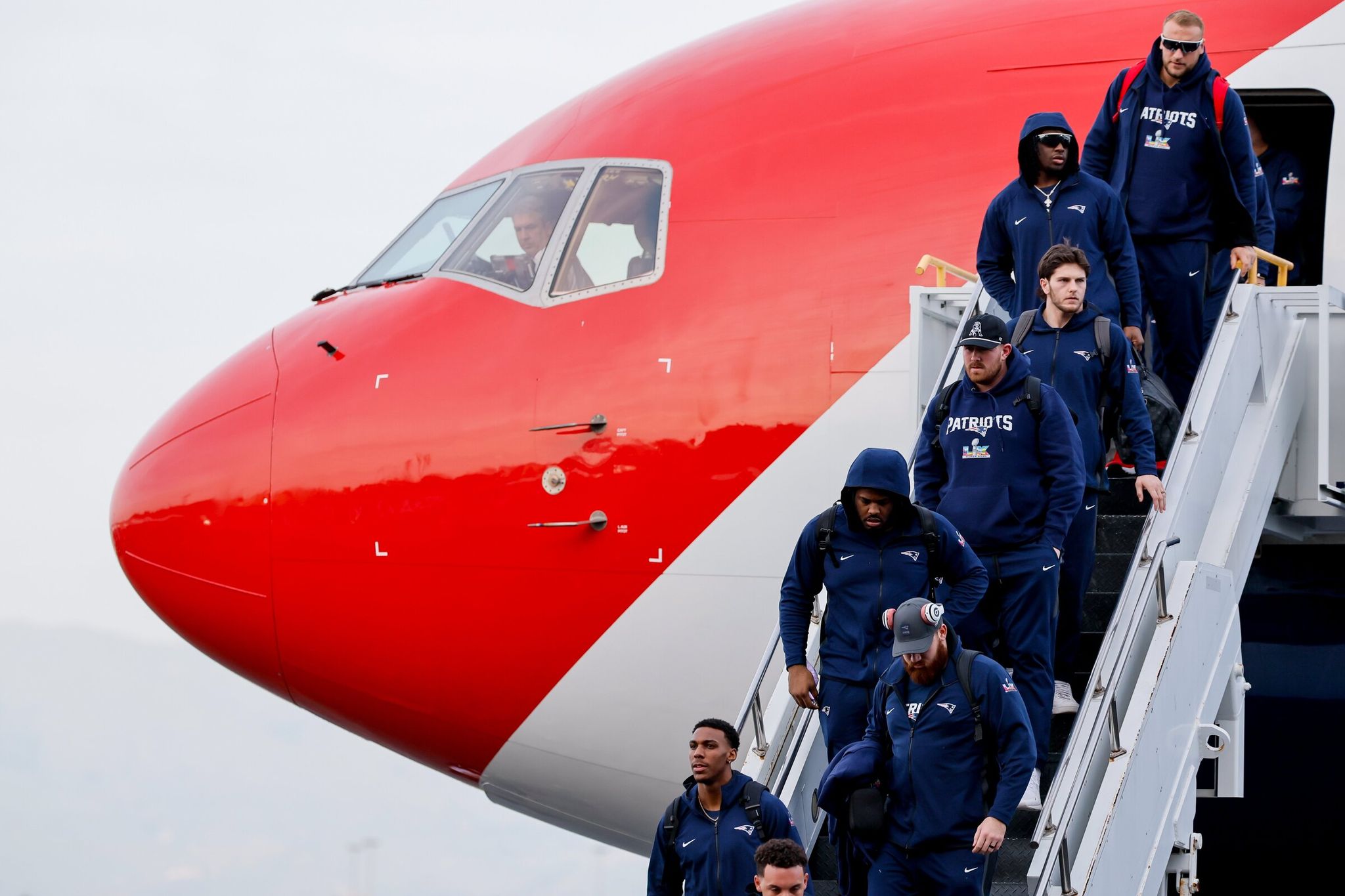 The New England Patriots team arrives at San José airport on Sunday. (Jennifer Buchanan / The Seattle Times)