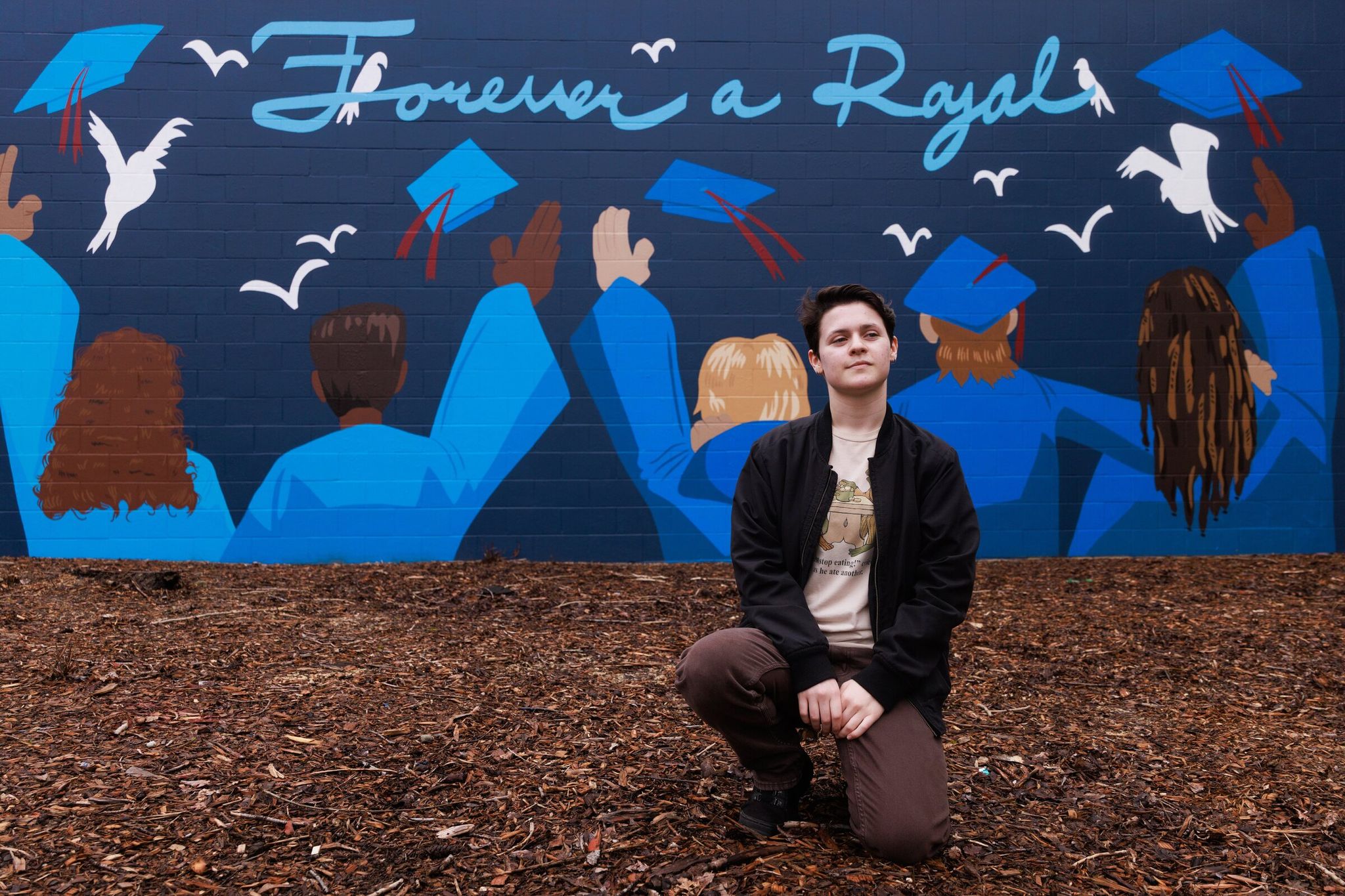 Ellie Hoyt, a 12th-grade student at Kent‑Meridian High School, co-designed the mural on campus with classmate Harlan McManus (not pictured) to commemorate classmates who died before graduation. (Erika Schultz / The Seattle Times)