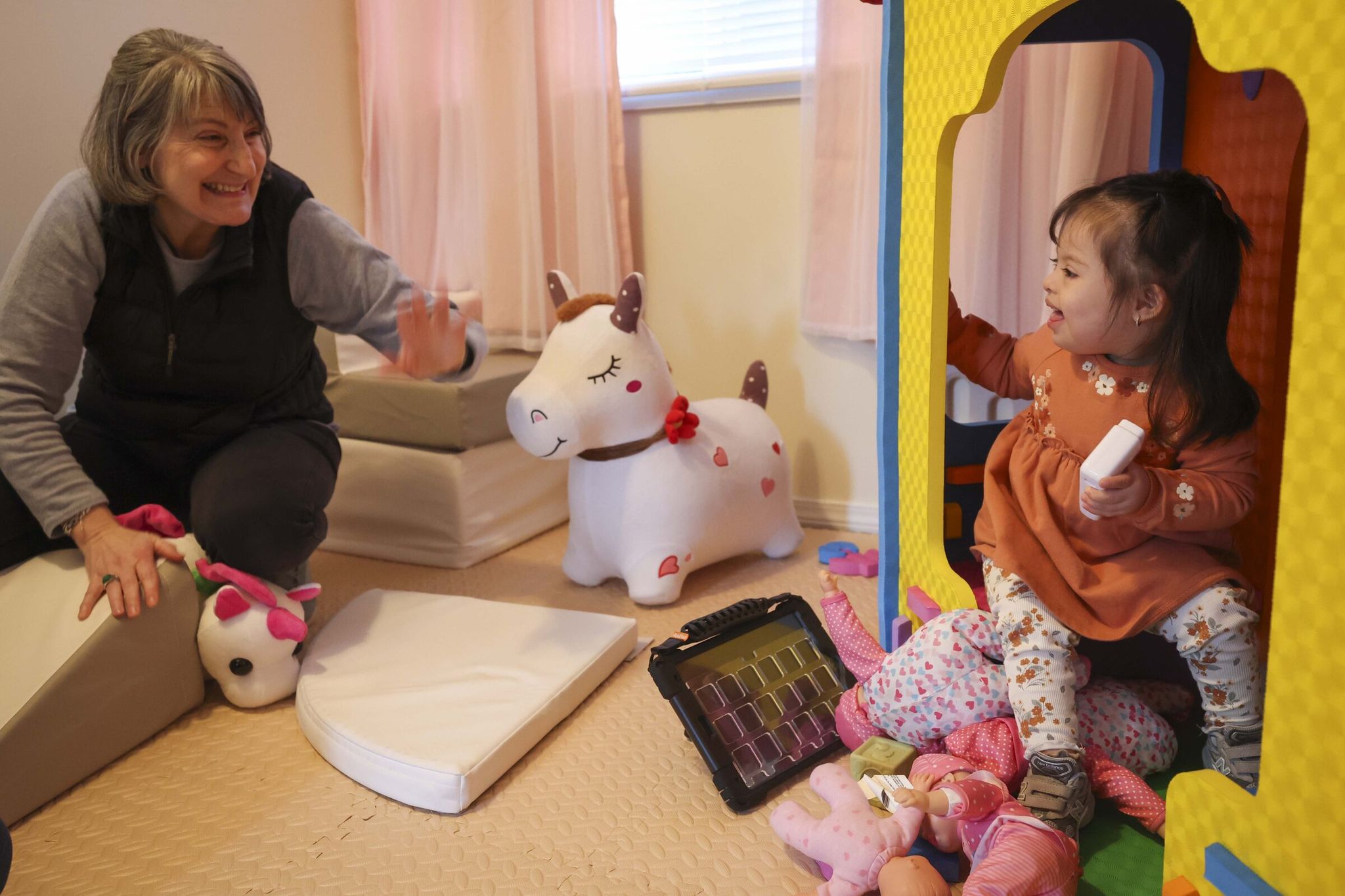 Yasmin Guzman plays with her daughter Emma, 2, at their home in Bothell. Kindering, a local nonprofit supported by The Seattle Times Fund for Those in Need, helps Emma, who was born with Down syndrome and heart defects, and her family. (Ivy Seballo / The Seattle Times, 2025)