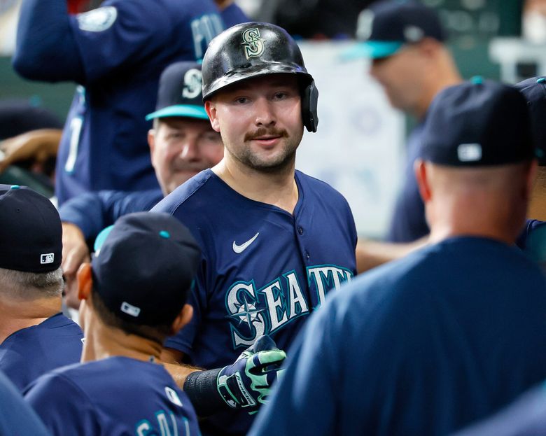 Seattle Mariners catcher Cal Raleigh chats with teammates in the dugout after Raleigh hit his 57th home run of the season during the third inning Saturday, Sept. 20, 2025 in Houston. 231196 (Jennifer Buchanan / The Seattle Times)