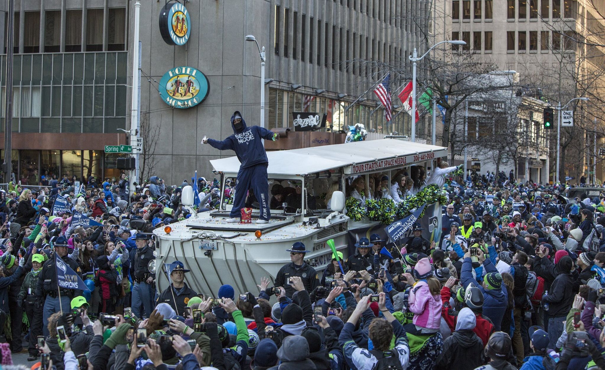 Marshawn Lynch tosses Skittles from the first Duck Boat during the Seattle Seahawks parade down Fourth Avenue in downtown Seattle in 2014. (Steve Ringman / The Seattle Times)