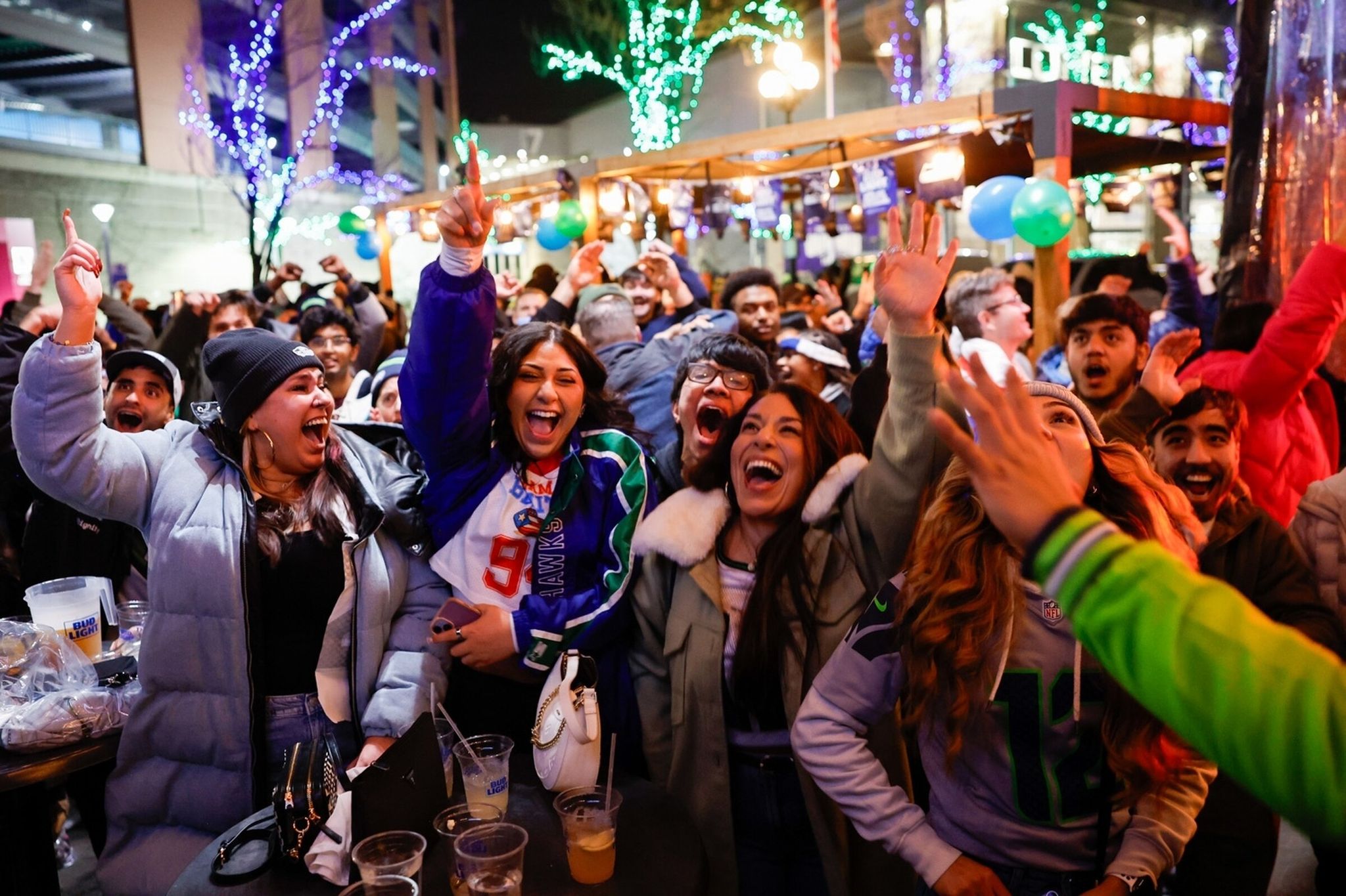 Fans react at Gantry Public House after the Seahawks scored in the 4th quarter while watching Super Bowl LX in Seattle on Sunday, Feb. 8, 2026. (Karen Ducey / The Seattle Times)