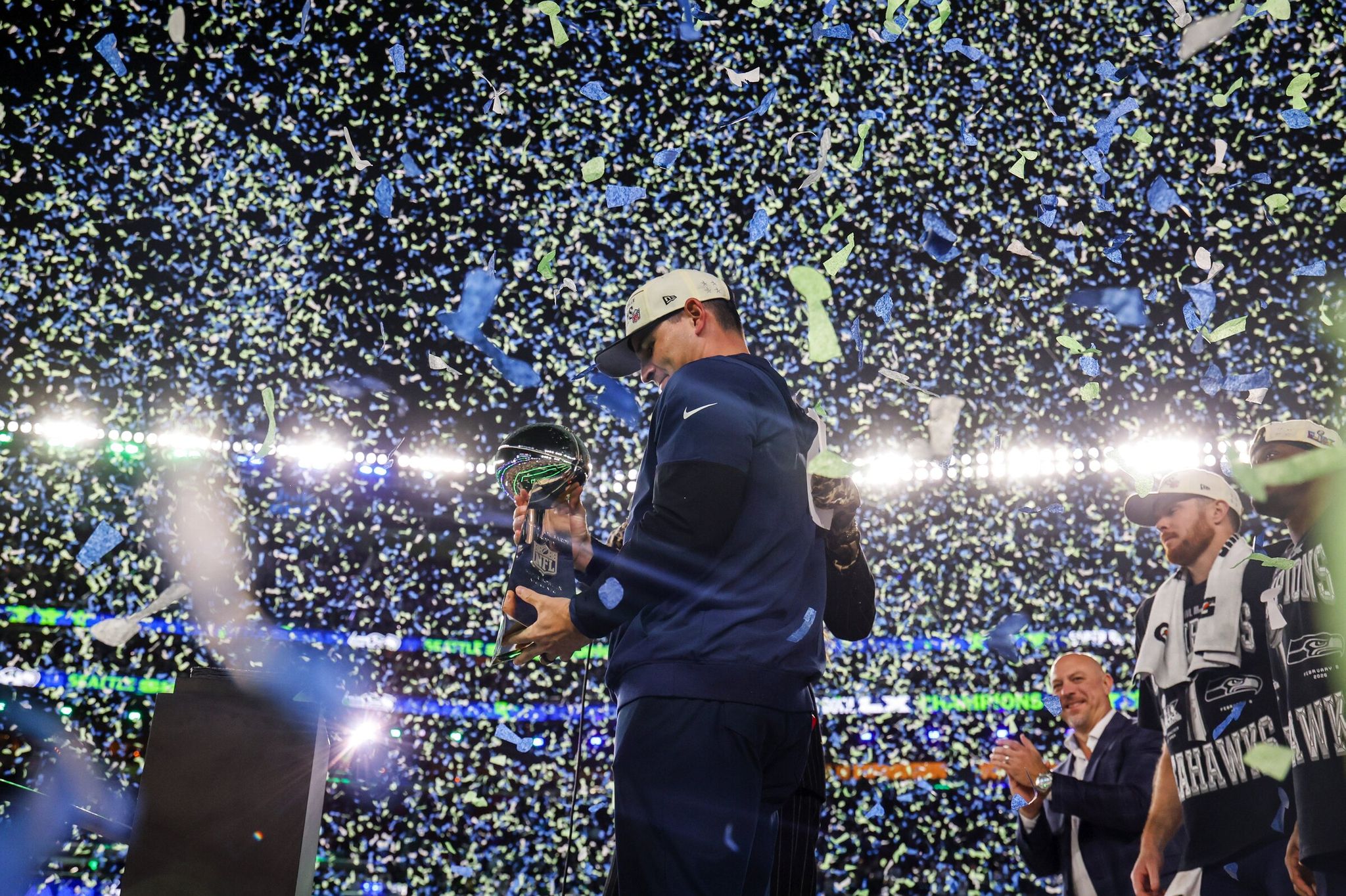Seahawks head coach Mike Macdonald looks at the Lombardi Trophy as blue and green confetti rains down on the field after the Seahawks defeated the Patriots in Super Bowl LX on Sunday, Feb. 8, 2026, in Santa Clara, Calif. (Jennifer Buchanan / The Seattle Times)