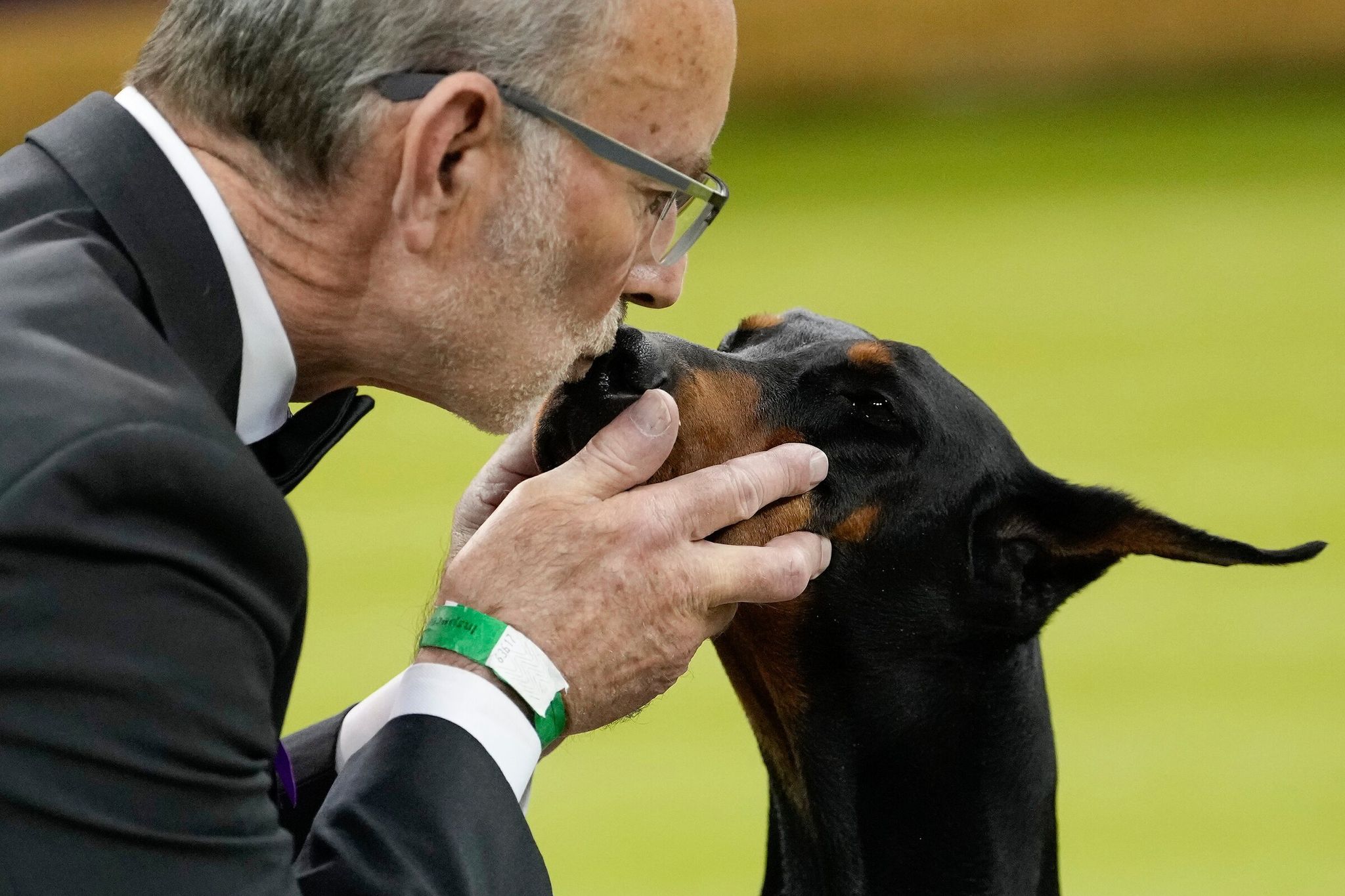 Penny, a Doberman pinscher, receives a kiss from handler Andy Linton after winning Best in Show at the 150th Westminster Kennel Club dog show Tuesday, Feb. 3, in New York. (Yuki Iwamura / AP)
