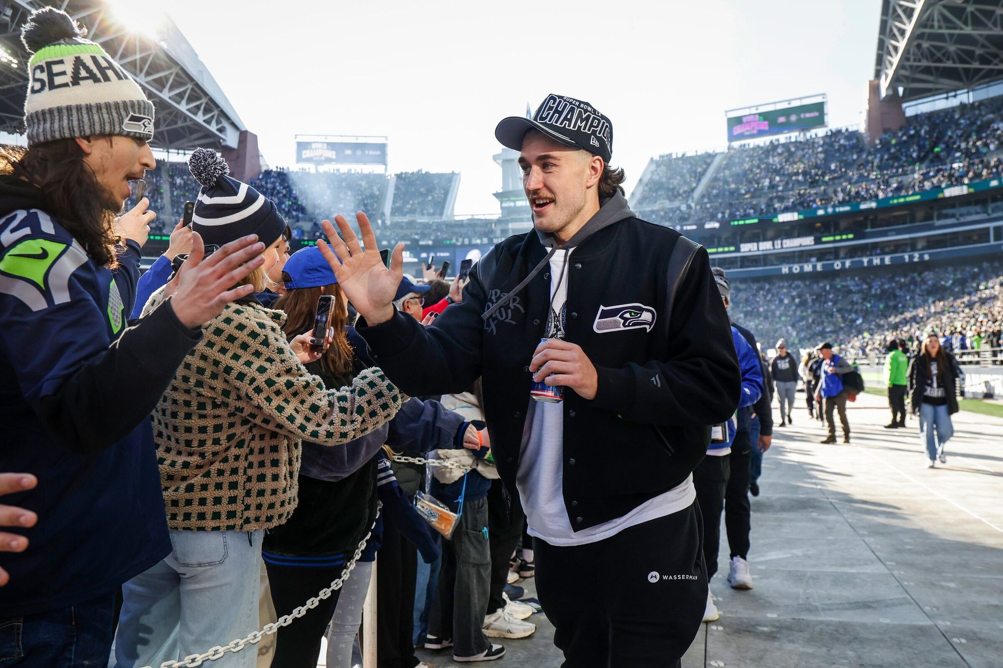 Jake Bobo and other players arrive at Lumen Field as the Seattle Seahawks celebrate their Super Bowl 60 win. (Dean Rutz / The Seattle Times)