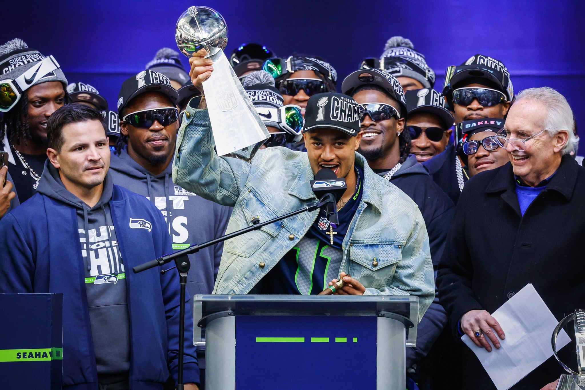 Wide receiver Jackson Smith-Njigba lifted the Lombardi Trophy as the Seahawks celebrated their Super Bowl 60 win during a trophy ceremony at Lumen Field on Wednesday. (Dean Rutz / The Seattle Times)
