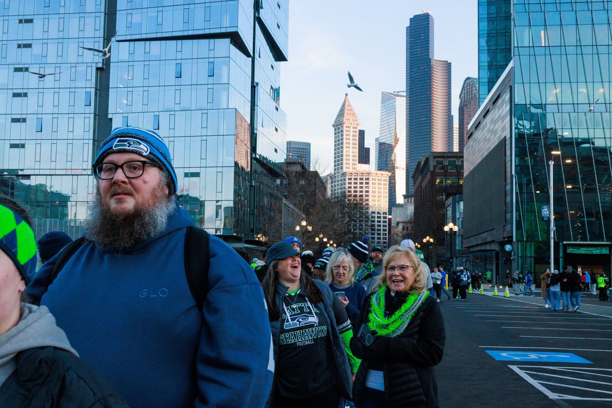 Ethel Green, with light hair, and Ana Capps wait in line to take photos at Lumen Field before the Seattle Seahawks parade in Seattle on Wednesday, Feb. 11, 2026. (Erika Schultz / The Seattle Times)