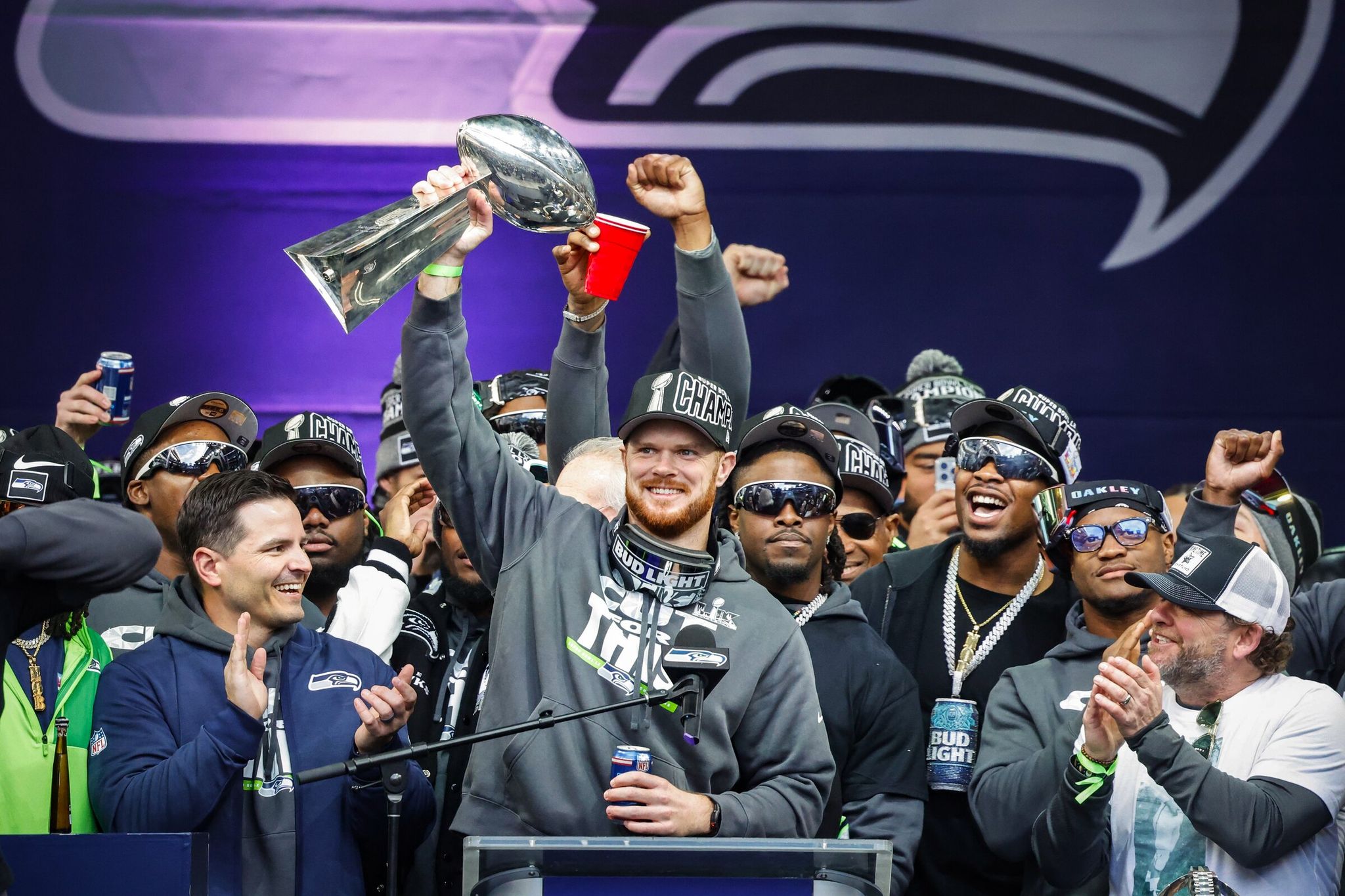Sam Darnold steps forward with the Lombardi Trophy as the Seattle Seahawks celebrate their Super Bowl win at a trophy ceremony at Lumen Field on Wednesday. (Dean Rutz / The Seattle Times)