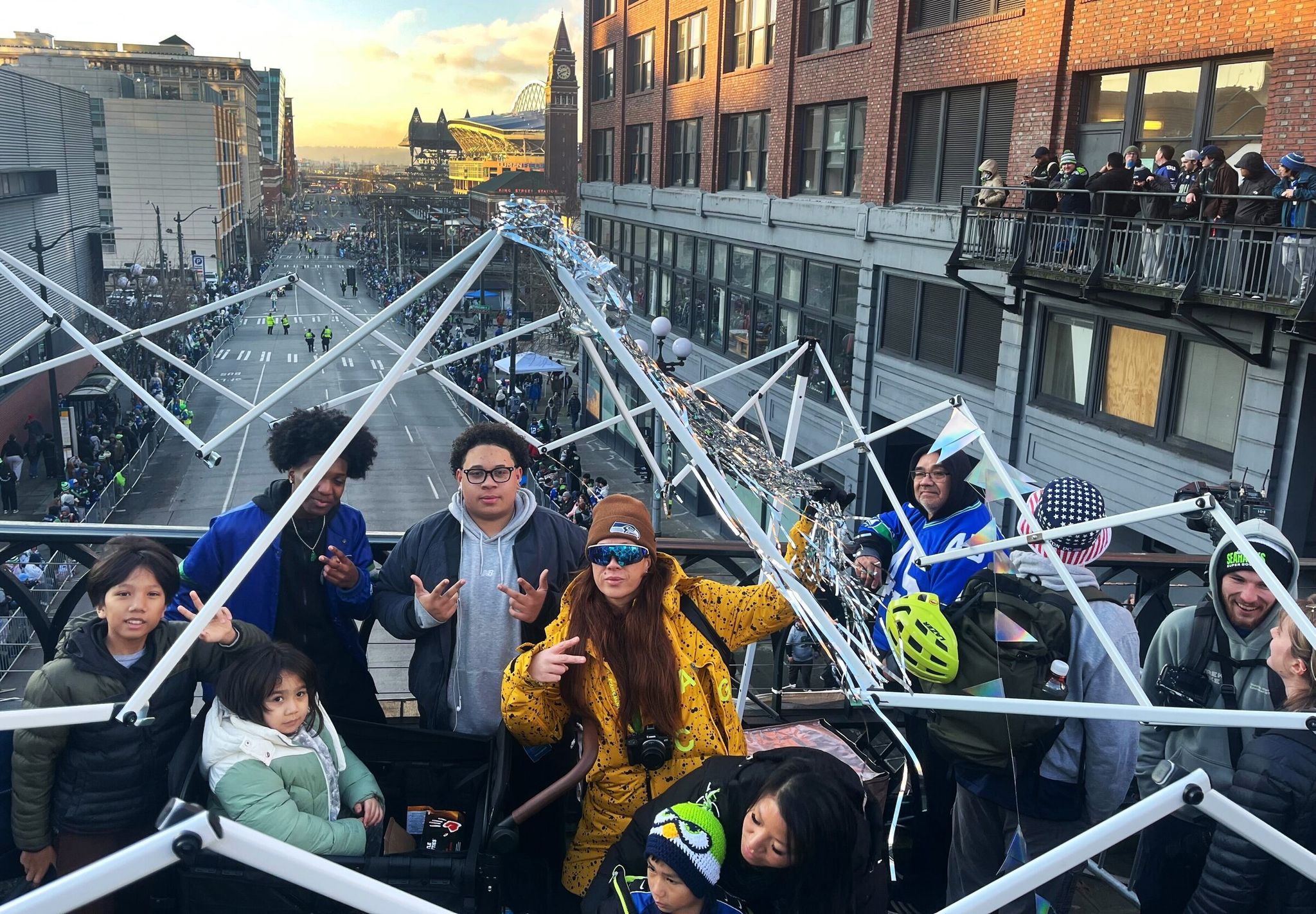 The Evelyn-Rose Phillips family claimed a prime viewing spot — a lookout for their family on Yesler Way above the action along Fourth Avenue. (Kai Uyehara / The Seattle Times)