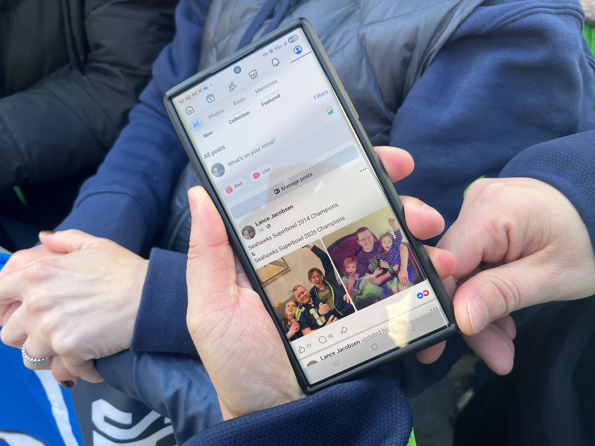Lance Jacobsen, father of three girls, proudly showed two photos he shared on Facebook after Sunday's game: one of him smiling holding his two older daughters, Kailey and Emma, after the 2014 Super Bowl, and another of the trio recreating that same photo 12 years later. (Catalina Gaitán / The Seattle Times)