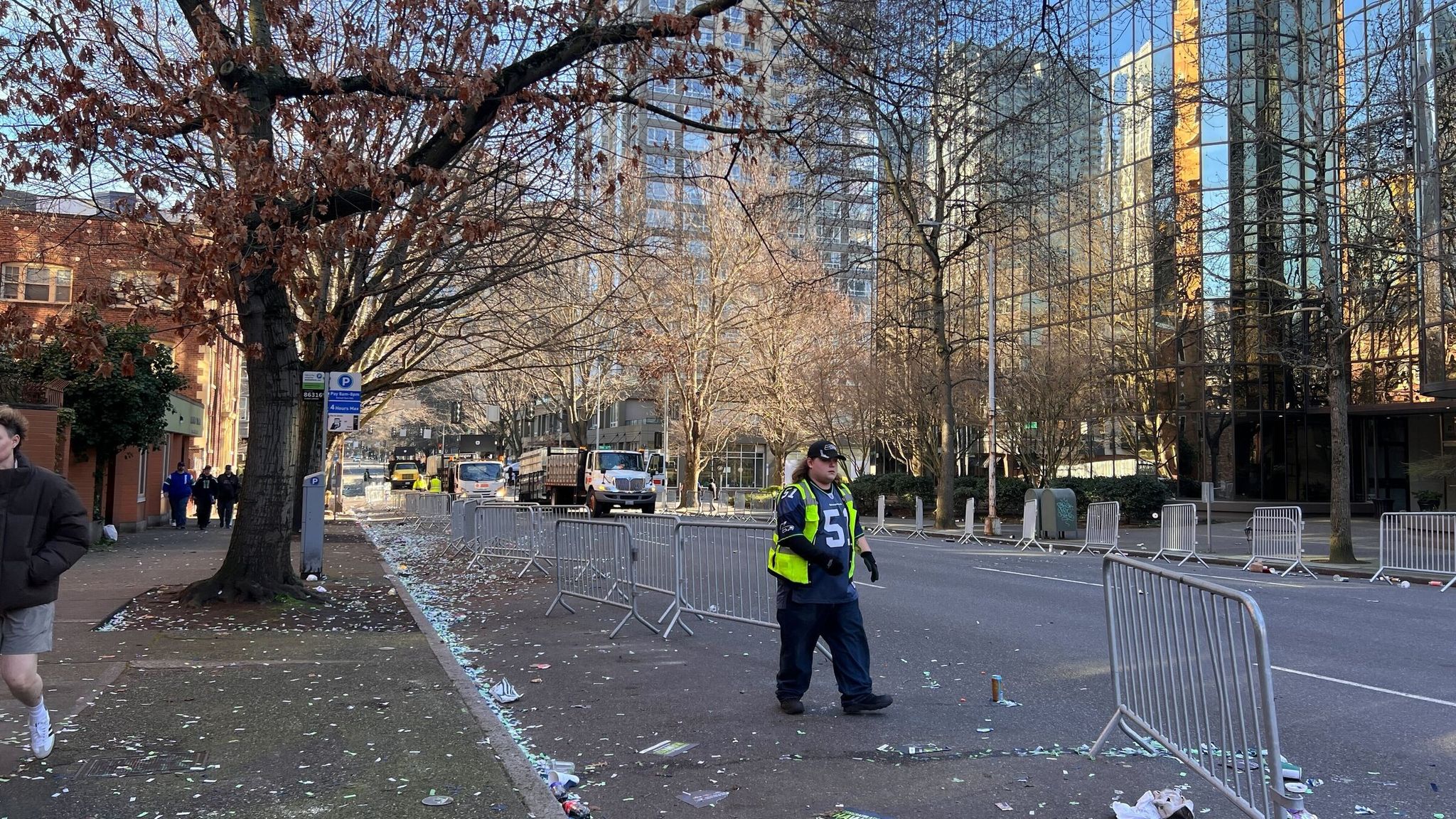 Seattle Parks and Recreation vehicles blocked access to a street on Denny Way while workers cleared the parade's last barricades. (Nicole Pasia / The Seattle Times)