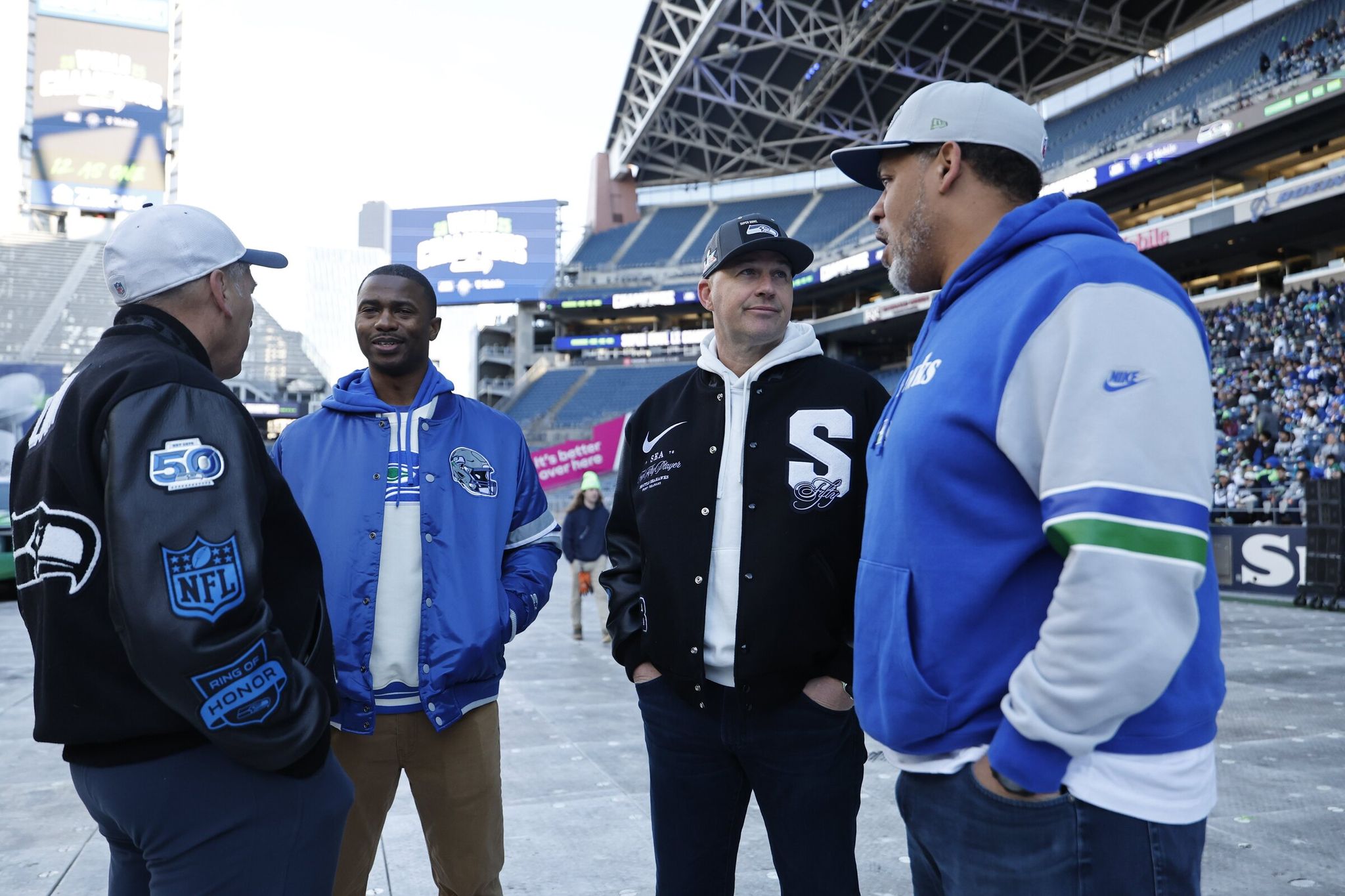 Matt Hasselbeck, Jim Zorn and other former players awaited Wednesday's trophy ceremony. (Dean Rutz / The Seattle Times)