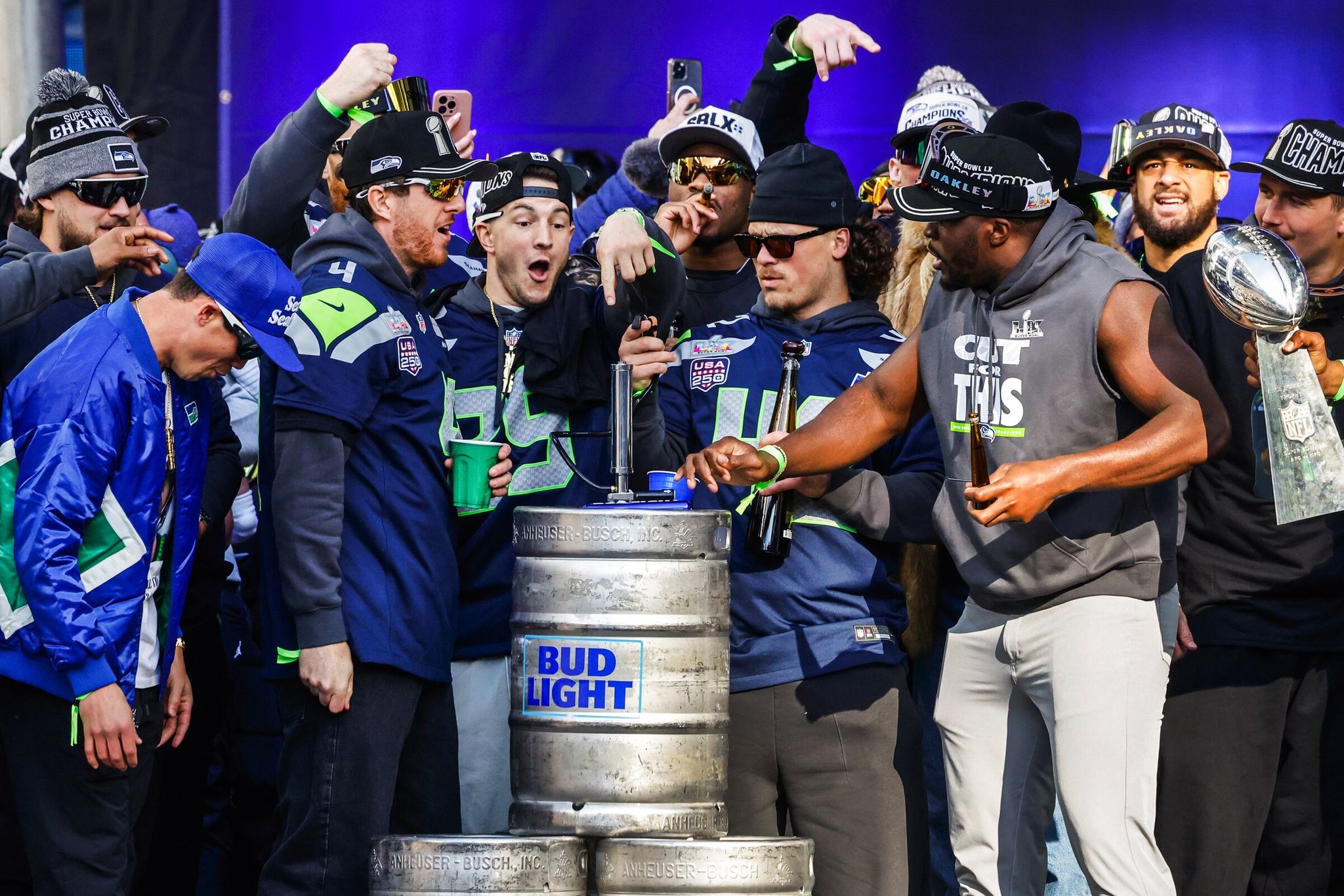 Players smash a Bud Light keg as the Seahawks celebrate their Super Bowl 60 win during a trophy ceremony at Lumen Field and a downtown parade on Wednesday. (Dean Rutz / The Seattle Times)