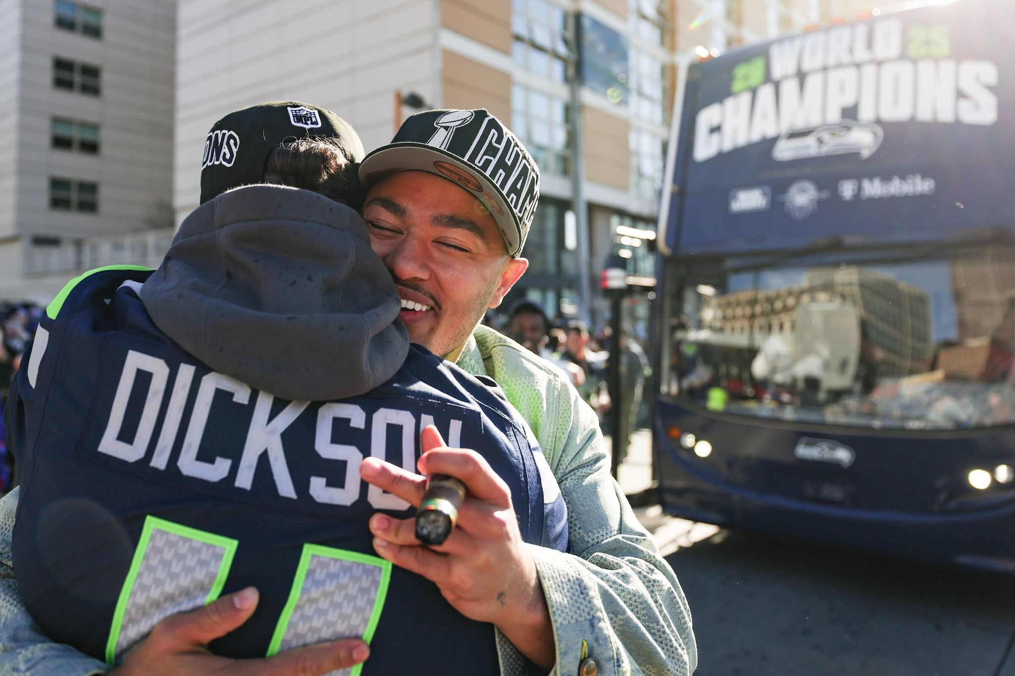 Seahawks receiver Jackson Smith-Njigba hugs Michael Dixon's mascot as thousands gathered to celebrate the Seahawks' Super Bowl championship on Wednesday, Feb. 11, 2026, in Seattle. (Nick Wagner / The Seattle Times)