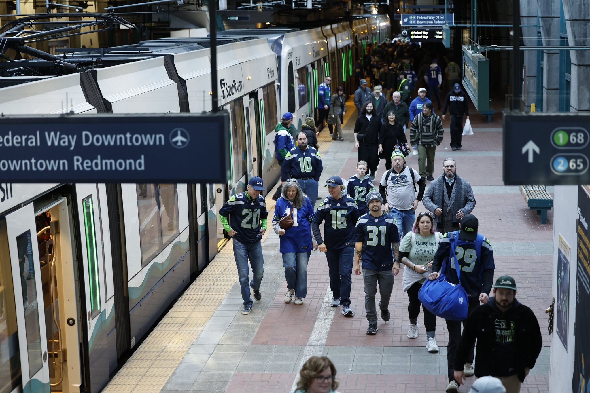 Seattle’s International District/Chinatown station, shown here filled with Seahawks fans on Wednesday, will soon be much busier as a hub for Lines 1 and 2. (Karen Ducey / The Seattle Times)