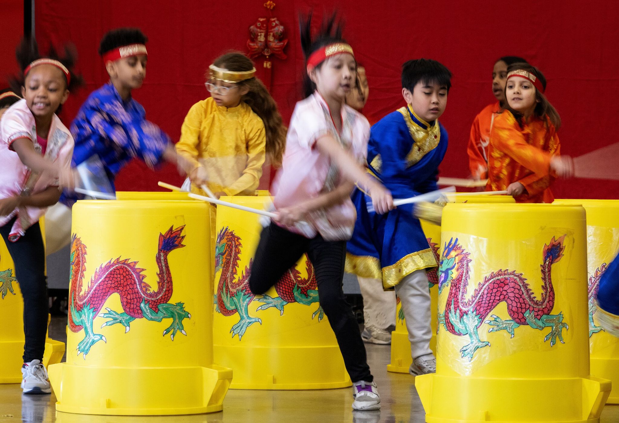 Students play drums during the Vietnamese/Chinese portion of the Lunar New Year program at Dearborn Park International Elementary in Beacon Hill, Seattle, on Feb. 10. (Ken Lambert / The Seattle Times)