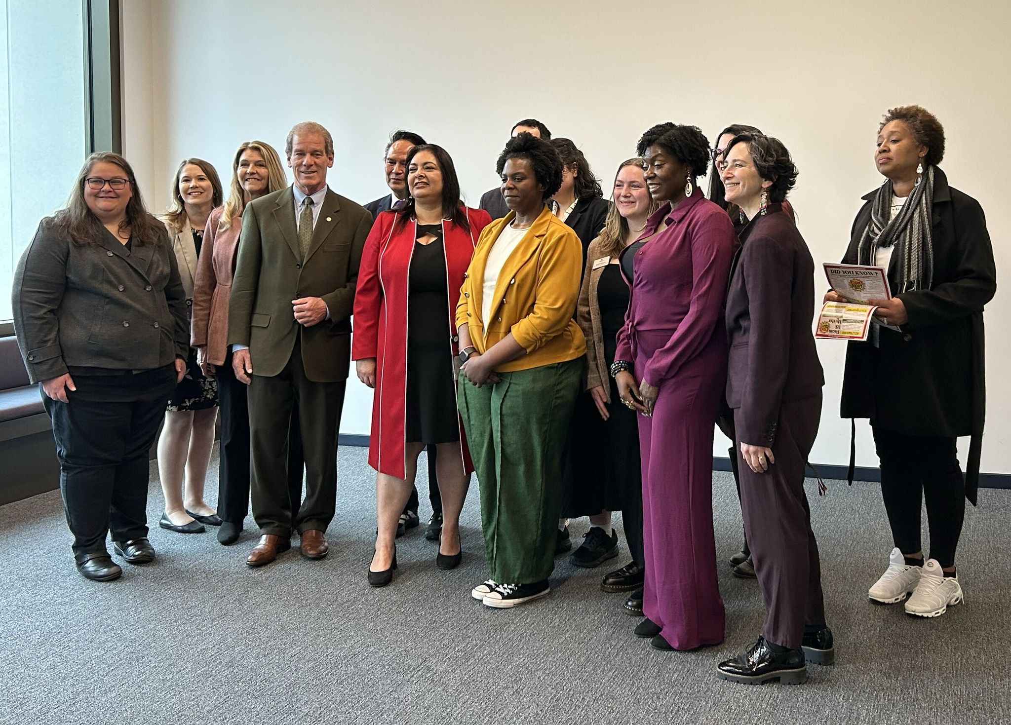 Washington state legislators gather after a Friday news conference focused on helping survivors of domestic and sexual violence. (Sofia Sostrine / The Seattle Times)
