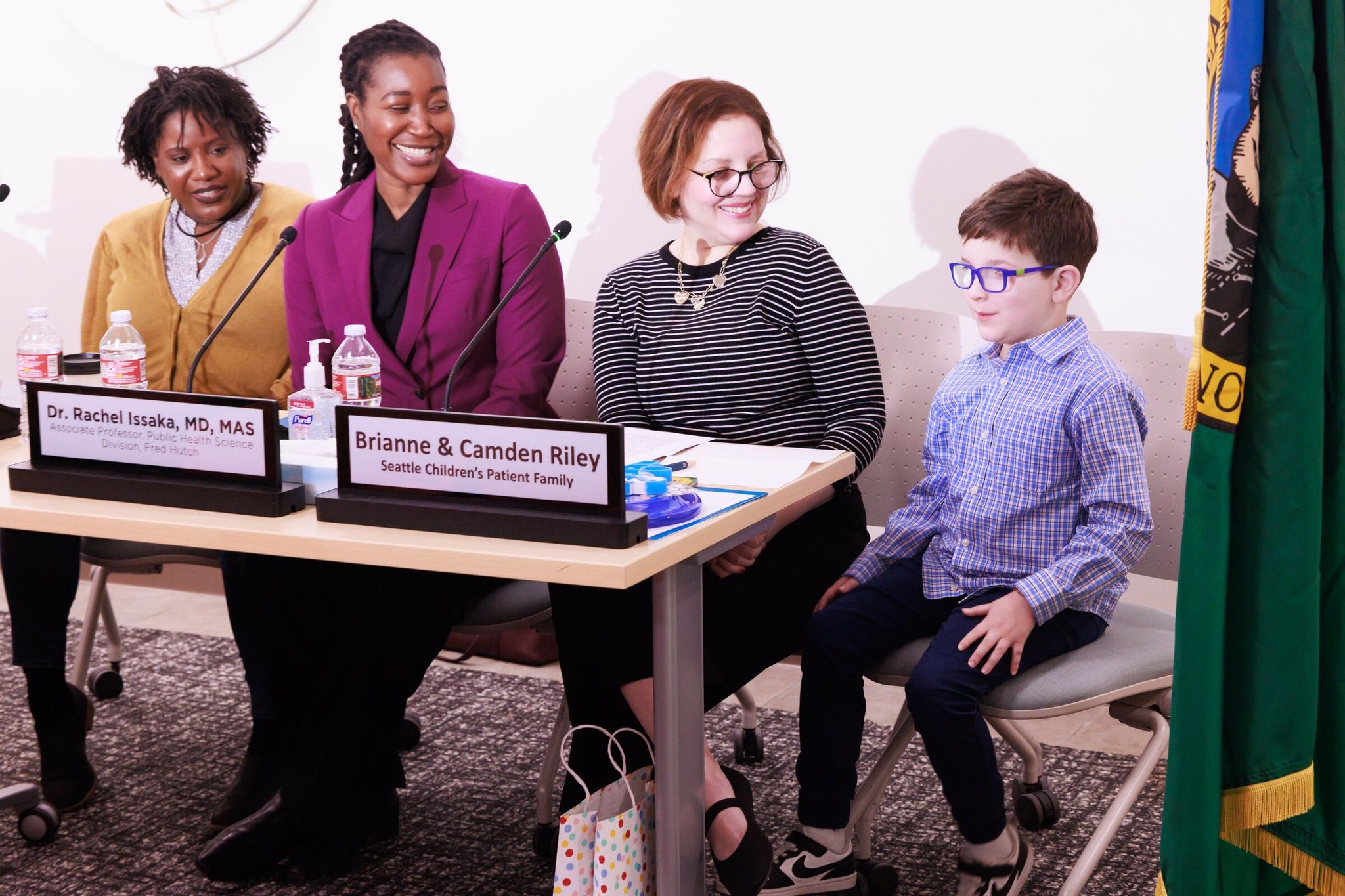 Briann Riley and her son Camden, right, who received care at Seattle Children’s, speak at a Friday press conference at the hospital. The Riley family, U.S. Senator Patty Murray and medical research leaders discussed Congressional approval of record NIH funding. Elizabeth Wayne, an associate professor of bioengineering at the University of Washington, is at far left, and Dr. Rachel Issaka, an assistant professor in public health at Fred Hutch Cancer Center, is second from left. (Erika Schultz / The Seattle Times)