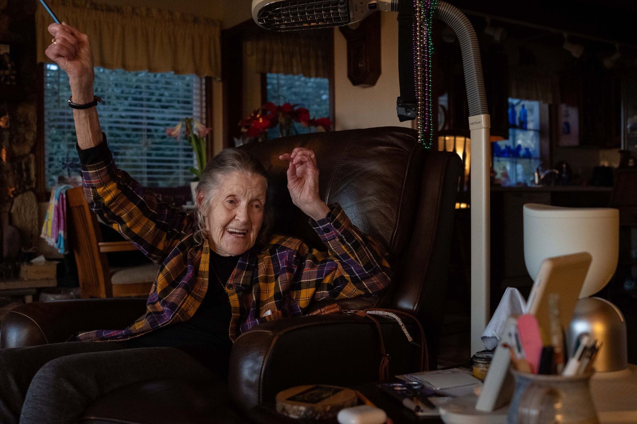 Jan reacts to winning a memory game against ElliQ. (Ruth Fremson/The New York Times)