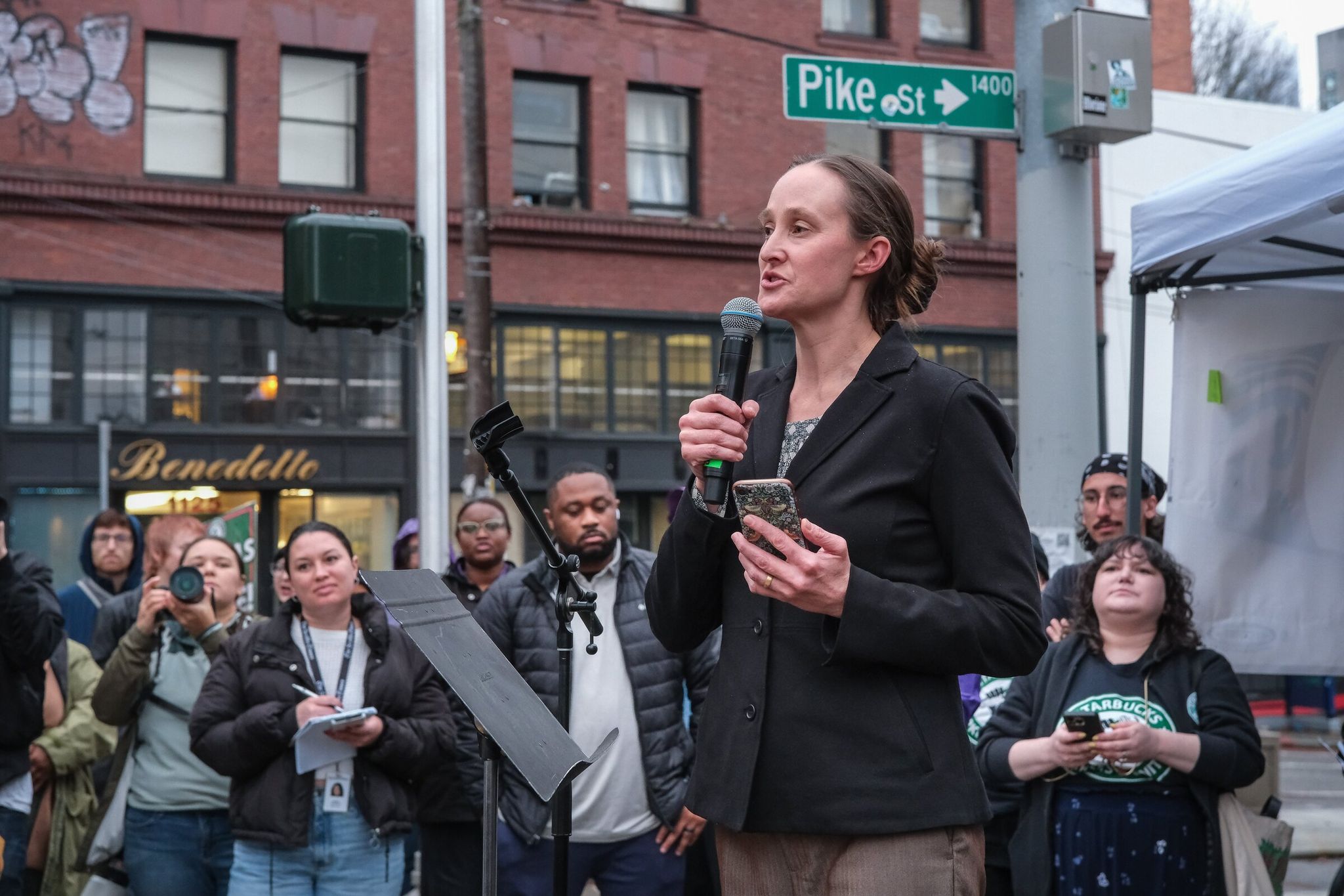 Katy Wilson, then the mayor-elect of Seattle, speaks to striking baristas in front of the former Starbucks Reserve roastery in Capitol Hill in November. Last week Wilson called the city ‘indecently wealthy.’ As politically incorrect as it may be, revenue from the new tax on large compensation packages shows she’s right, writes columnist Danny Westneat. (Dean Rutz / The Seattle Times, 2025)