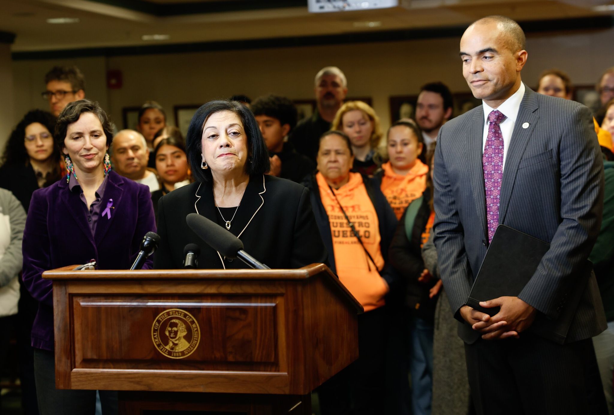 Representative Lillian Ortiz-Self speaks at a press conference on the Immigrant Worker Protection Act, Dec. 5, 2025, in Olympia. Washington Attorney General Nick Brown (right) and Senator Rebecca Saldaña (left) also spoke at the event. (Karen Ducey / The Seattle Times)