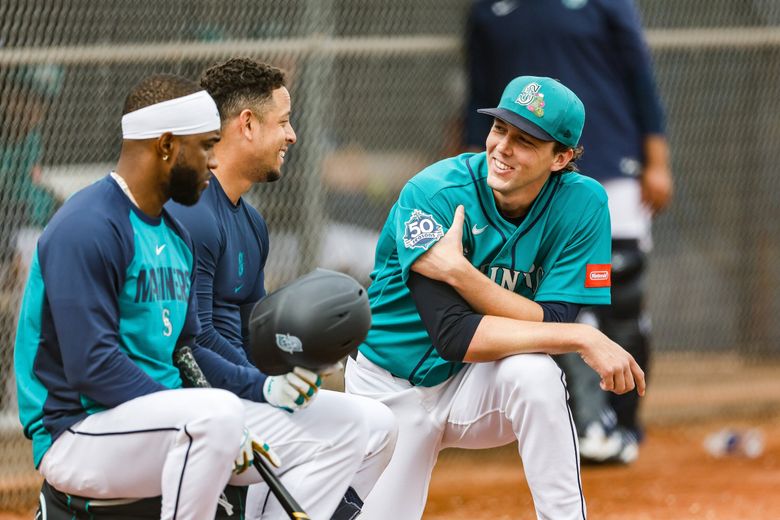 Logan Gilbert talks to Victor Robles, left, and Leo Rivas after Gilbert’s live batting practice session at Spring Training Monday, Feb. 16, 2026, in Peoria, Ariz. (Dean Rutz / The Seattle Times)
