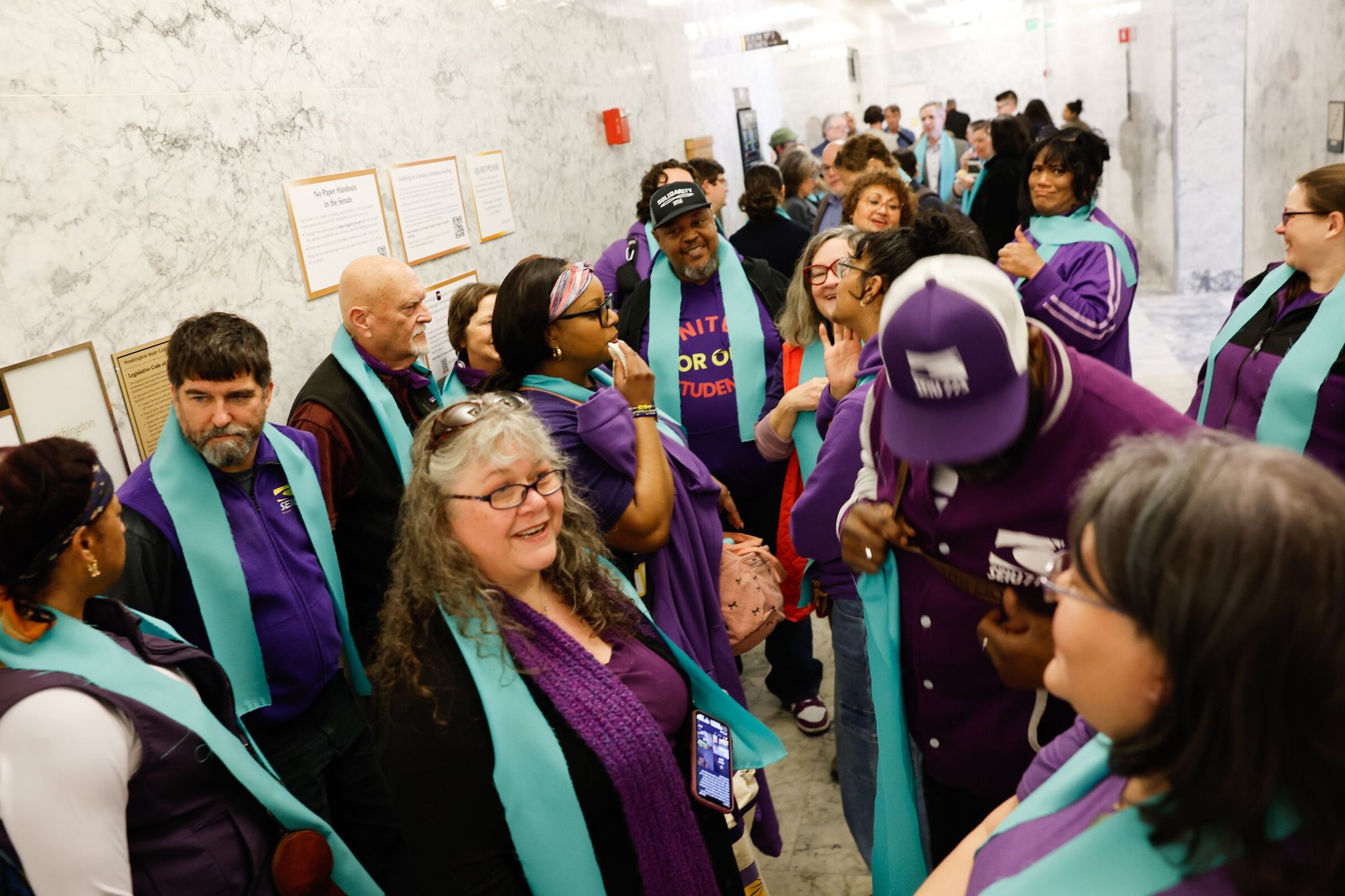 Sarah Hartson g of Shelton and other supporters of the proposed 'millionaires' tax' wait outside the hearing room before the first public hearing on the proposed tax before the Washington State Senate Ways & Means Committee on Feb. 6 in Olympia. (Karen Ducey / The Seattle Times)