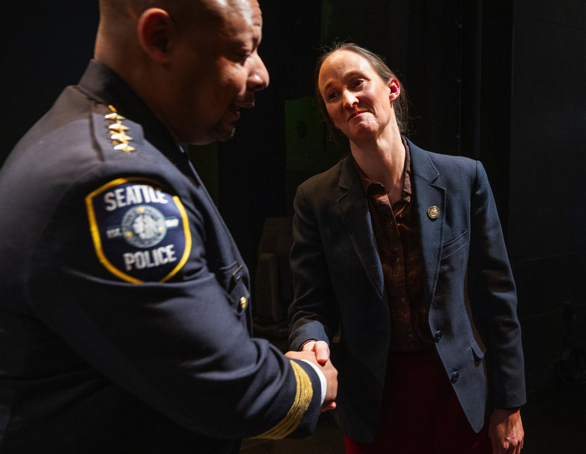Mayor Katie Wilson shakes hands with Seattle Police Chief Adrian Barnes after delivering the state of the city address on Tuesday in Seattle. (Ken Lambert / The Seattle Times)
