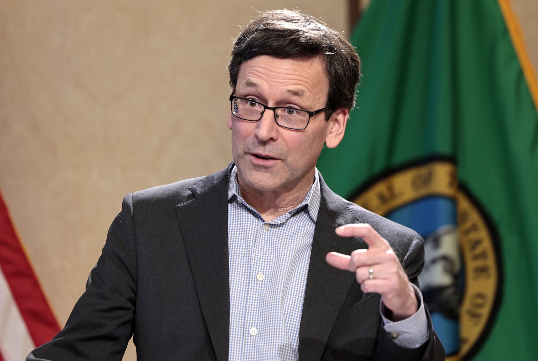 Governor Bob Ferguson holds a press conference to announce updated FEMA aid for recovery from December floods and share his latest thoughts on the state income-tax proposal in Olympia on Tuesday. (Karen Ducey / The Seattle Times)