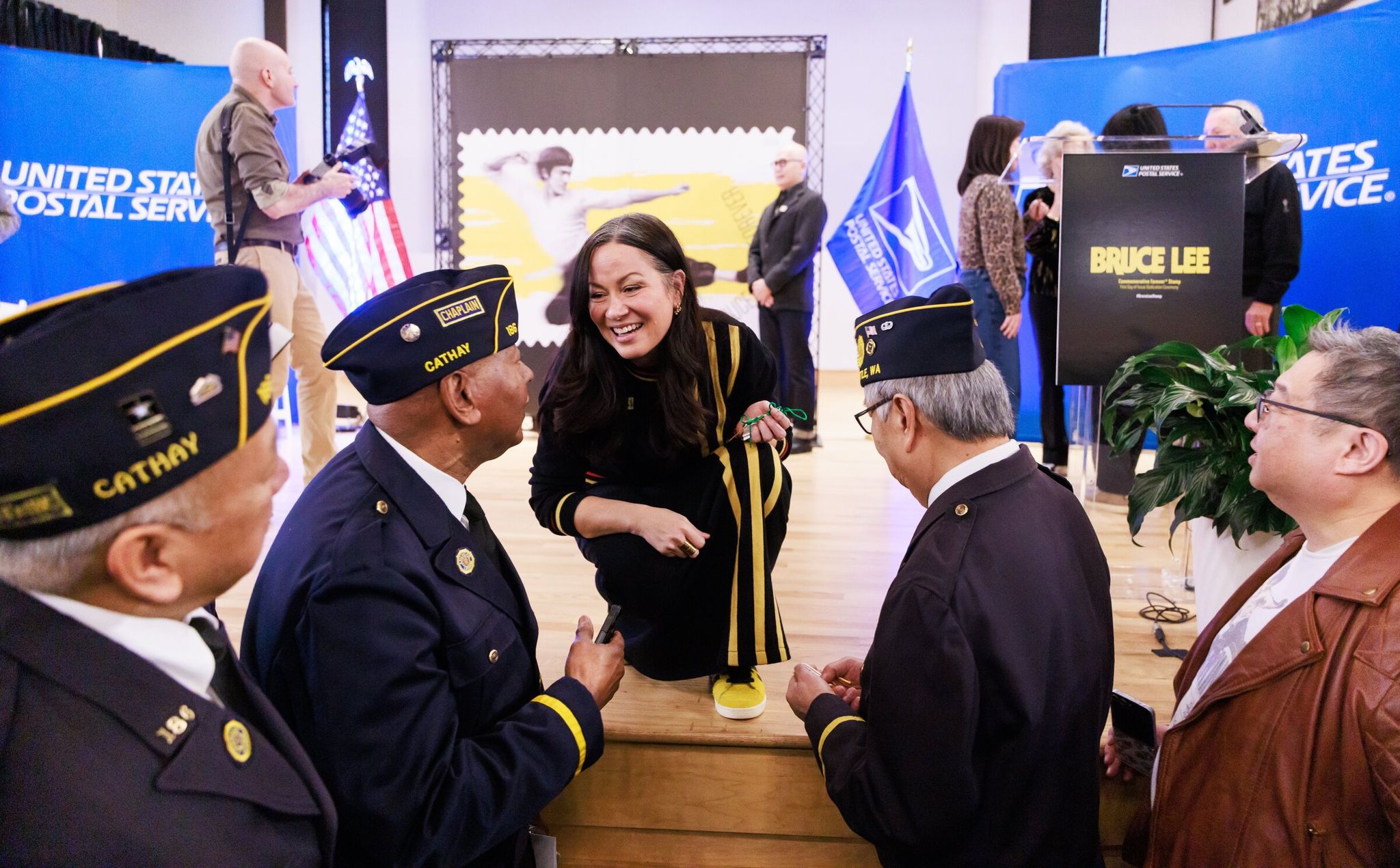 Shannon Lee, Bruce Lee’s daughter and CEO of Bruce Lee Enterprises, speaks with members of the honor guard from Post Cathay No. 186 of the American Legion at the Bruce Lee Forever stamp event on Wednesday at Nippon Kan theater in Seattle. (Erika Schultz / The Seattle Times)