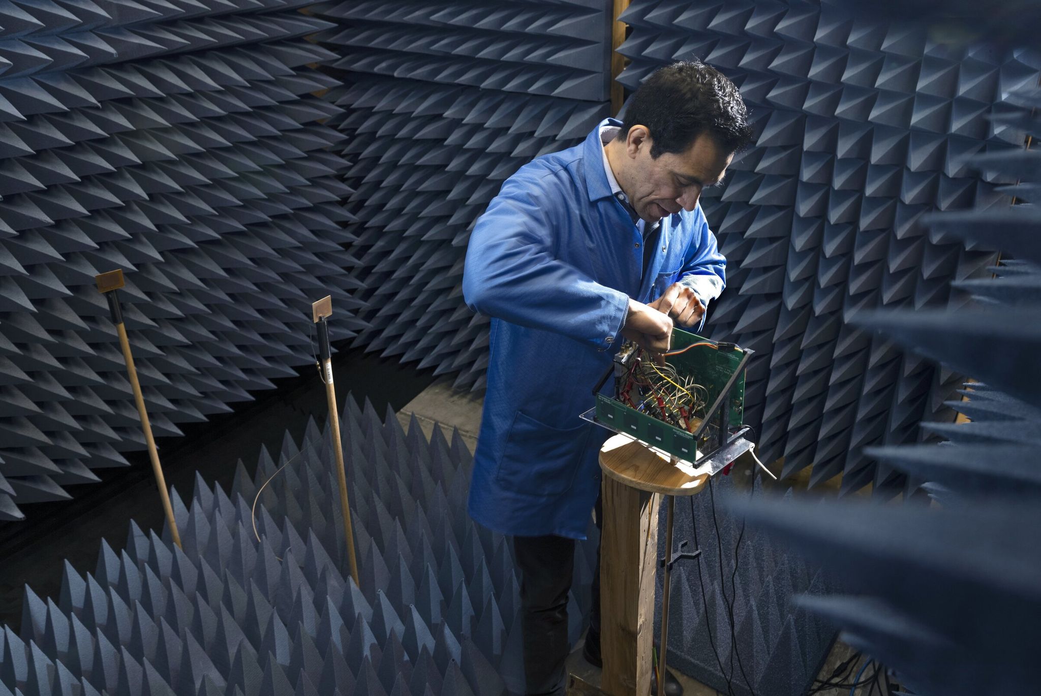 Jerry Lopez, co-founder of NoiseFigure Research, works in a chamber at the company’s headquarters in Renton. Over the past year the company absorbed tariff costs averaging 10% to 20% instead of raising prices for customers. (Ellen M. Banner / The Seattle Times, 2025)