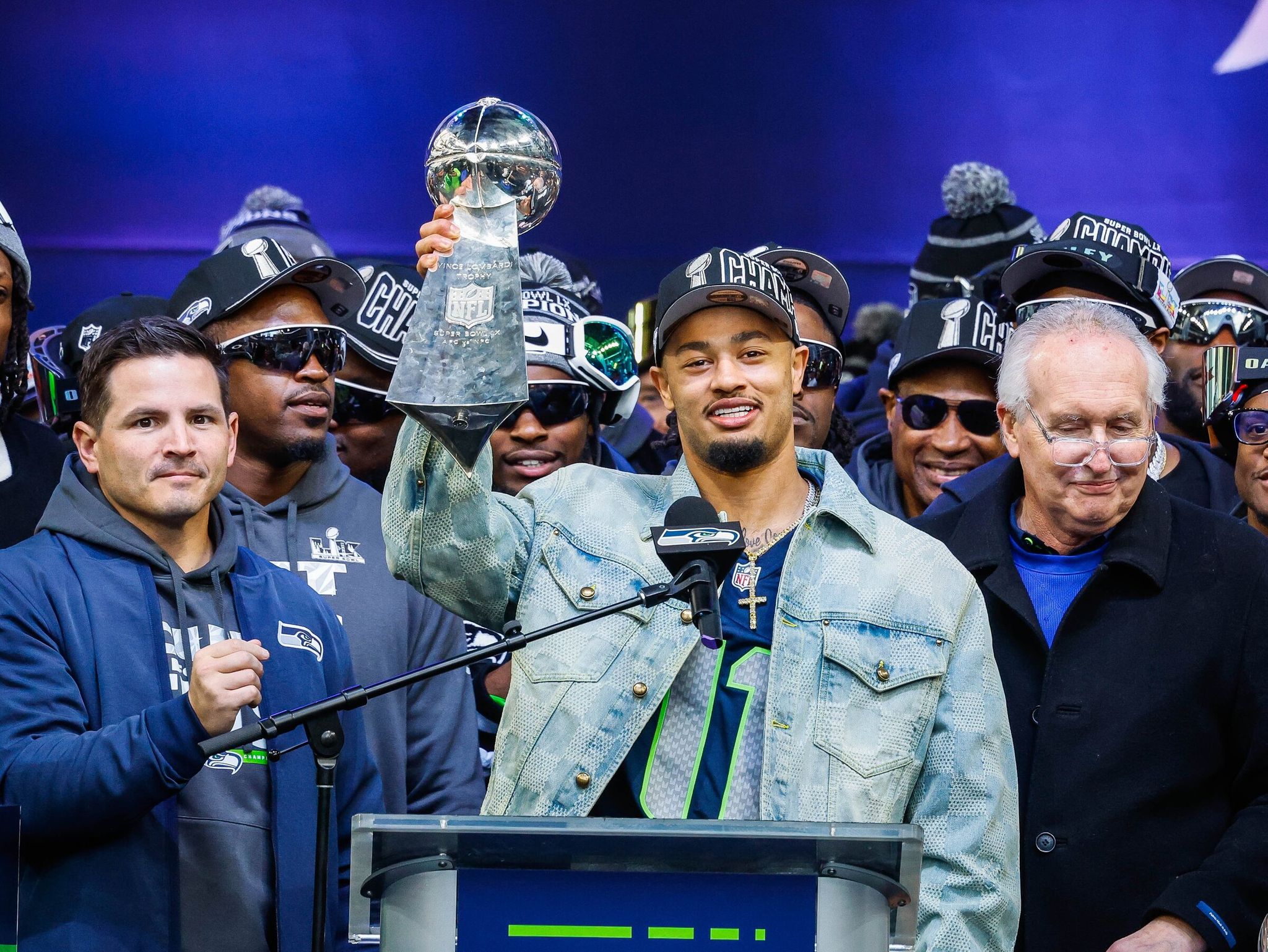 Jaxon Smith‑Njigba lifts the Lombardi Trophy during Super Bowl victory celebrations, February 11, 2026, at Lumen Field in Seattle. (Dean Rutz / The Seattle Times)