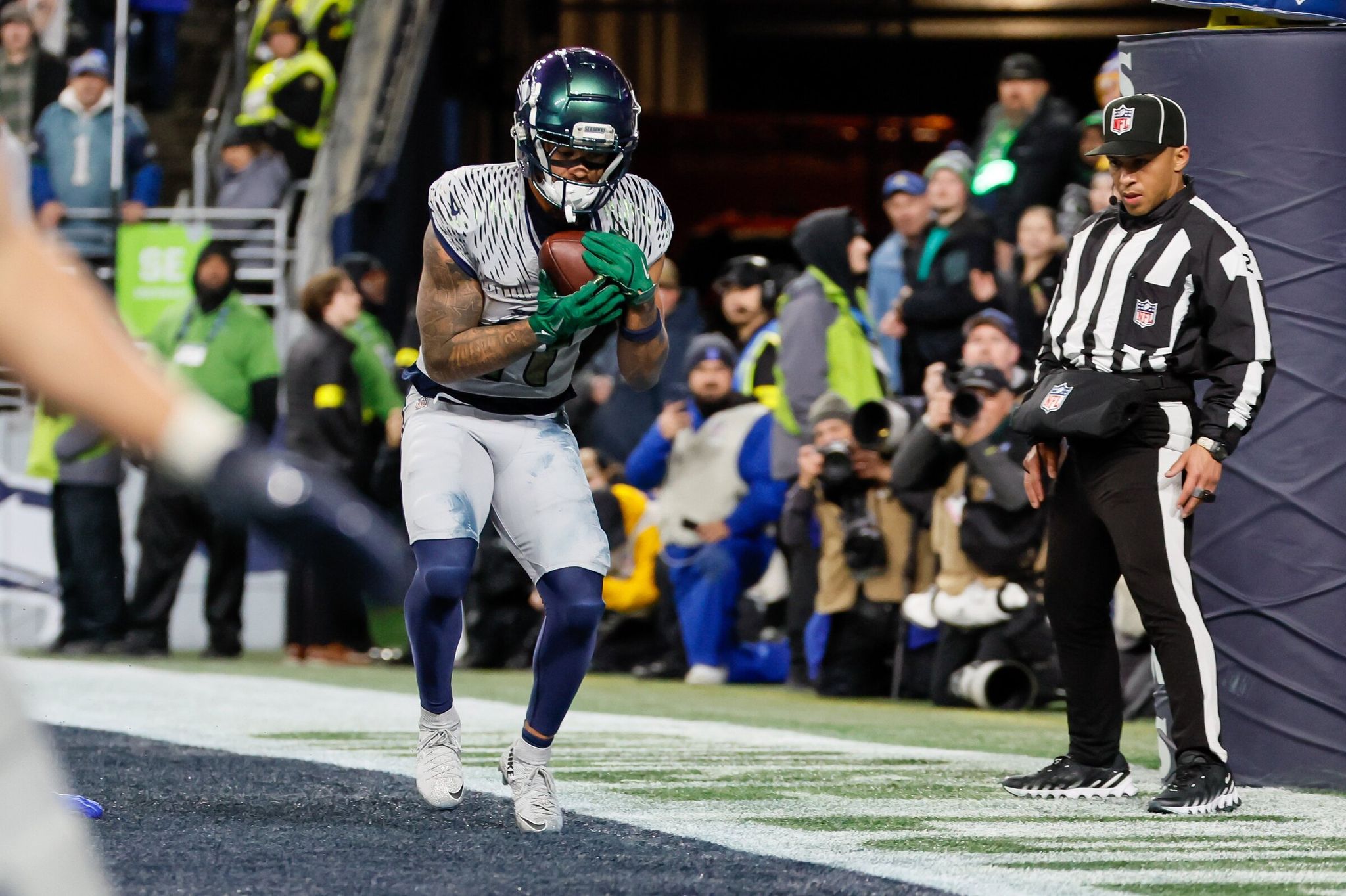Seattle Seahawks wide receiver Jaxon Smith‑Njigba toes the pylon on a touchdown reception in overtime against the Los Angeles Rams, December 18, 2025, in Seattle. (Jennifer Buchanan / The Seattle Times)