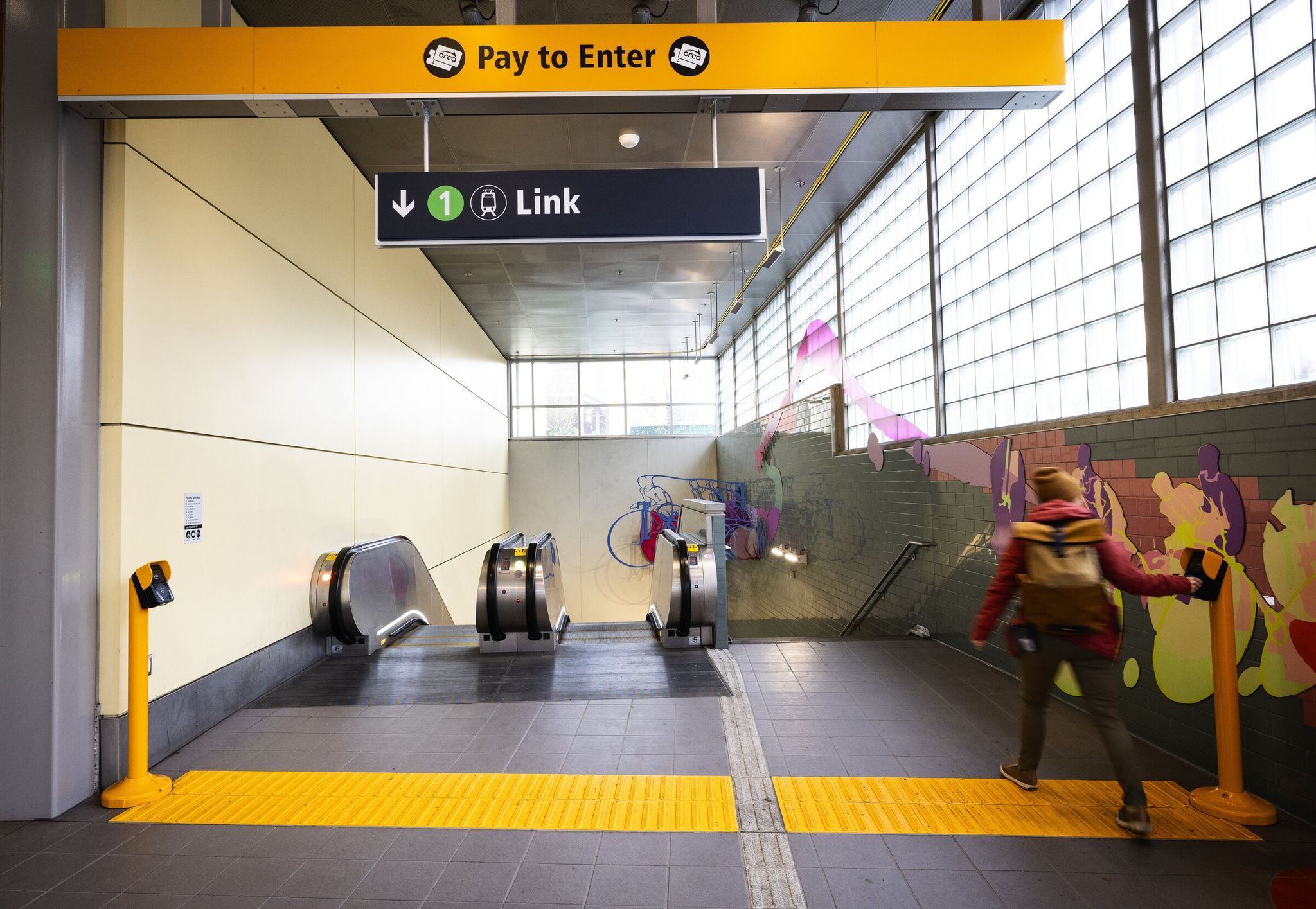 Passenger taps an ORCA card at the Roosevelt light rail station. Starting Monday, riders will be able to tap a smartphone, smart watch or a physical credit or debit card on the ORCA reader. (Ken Lambert / The Seattle Times, 2023)