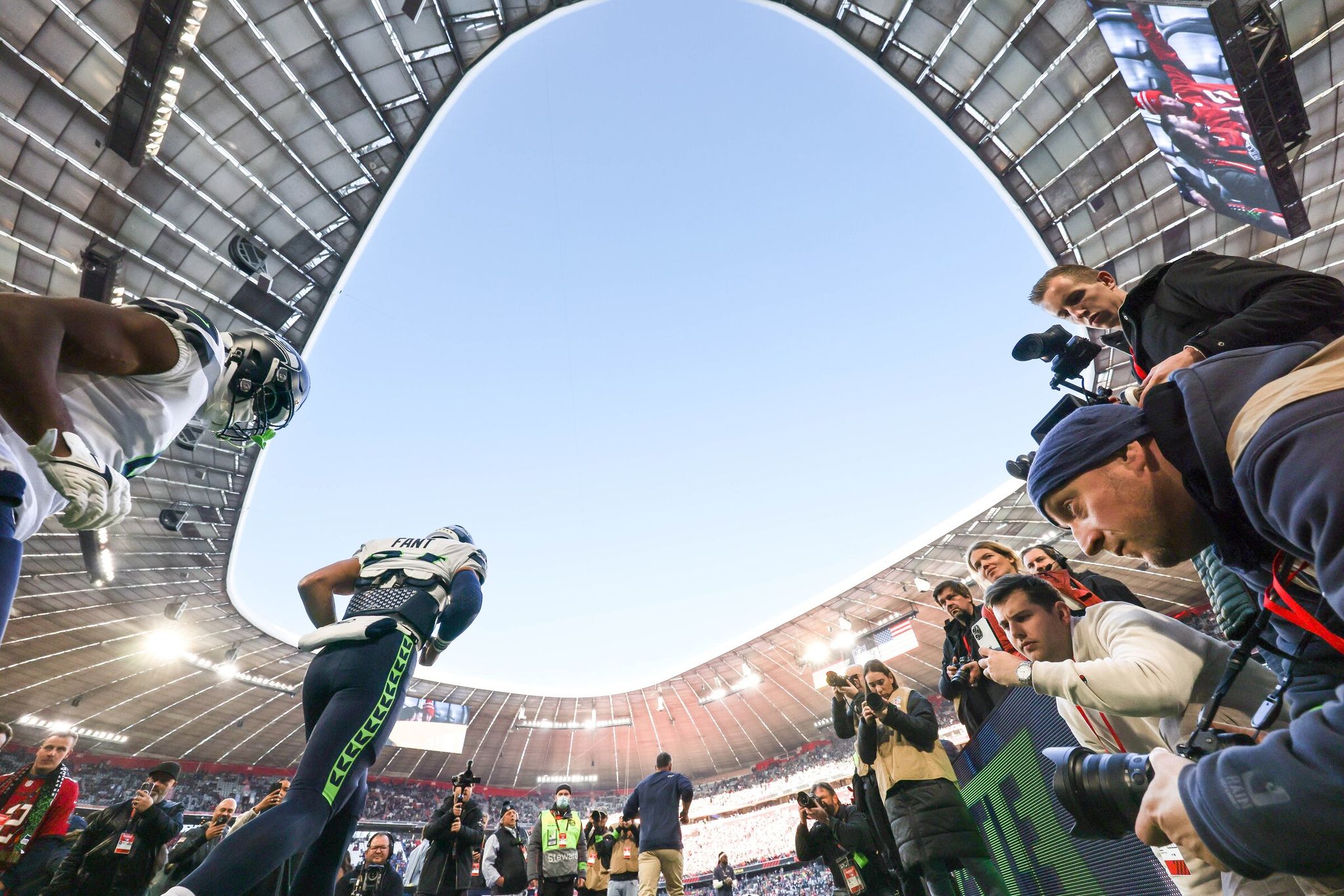 Seahawks take the field at FC Bayern’s home stadium for a match against the Buccaneers in 2022. (Dean Rutz / The Seattle Times)
