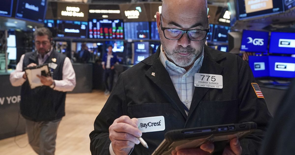 Wall Street flips to gains after government reports that consumer inflation cooled in January