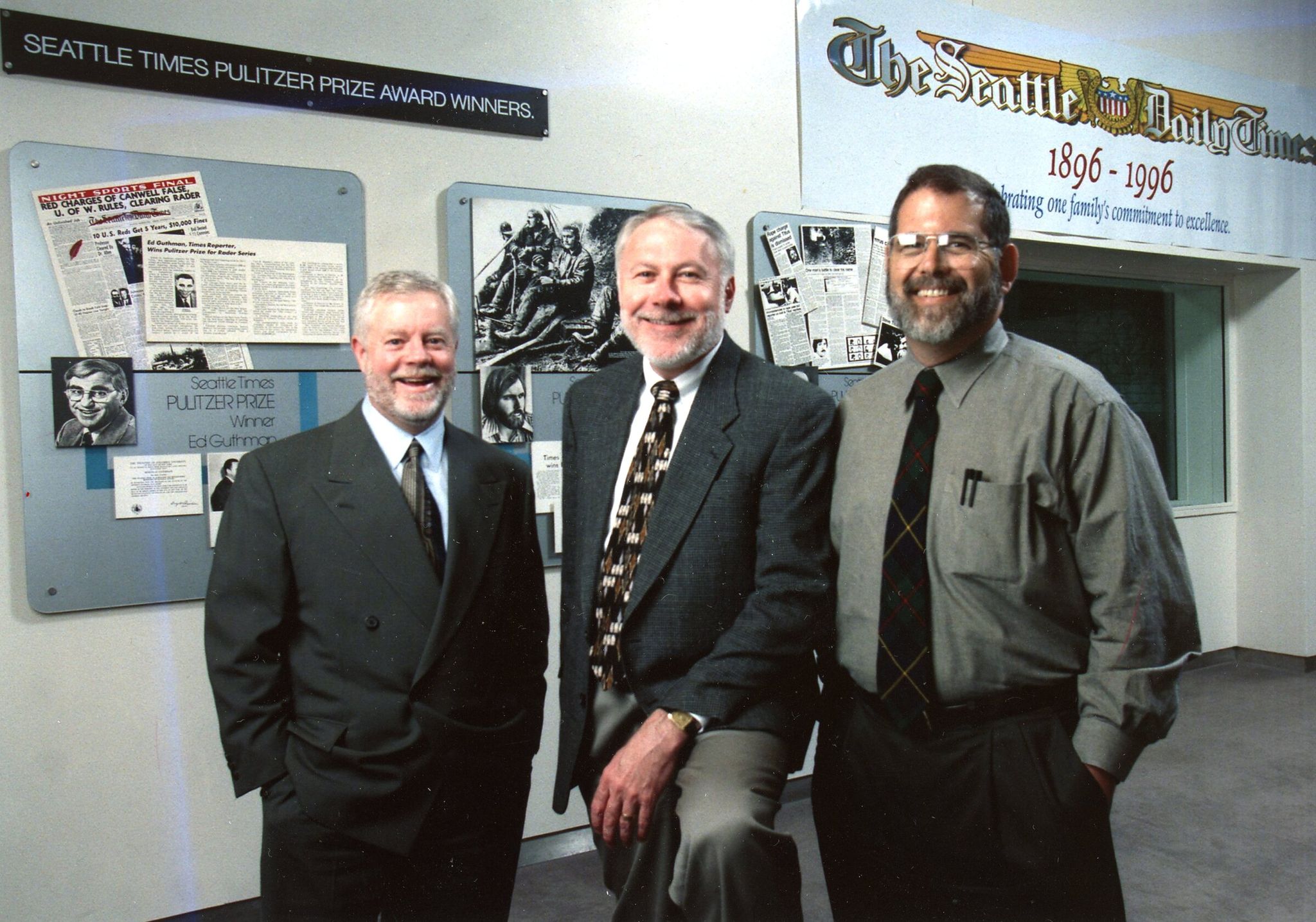 In 1997 publisher Frank Blethen, executive editor Mike Fancher and managing editor Alex MacLeod pose in front of a Pulitzer display in the lobby of the former Seattle Times building. (Benjamin Benschneider / The Seattle Times)
