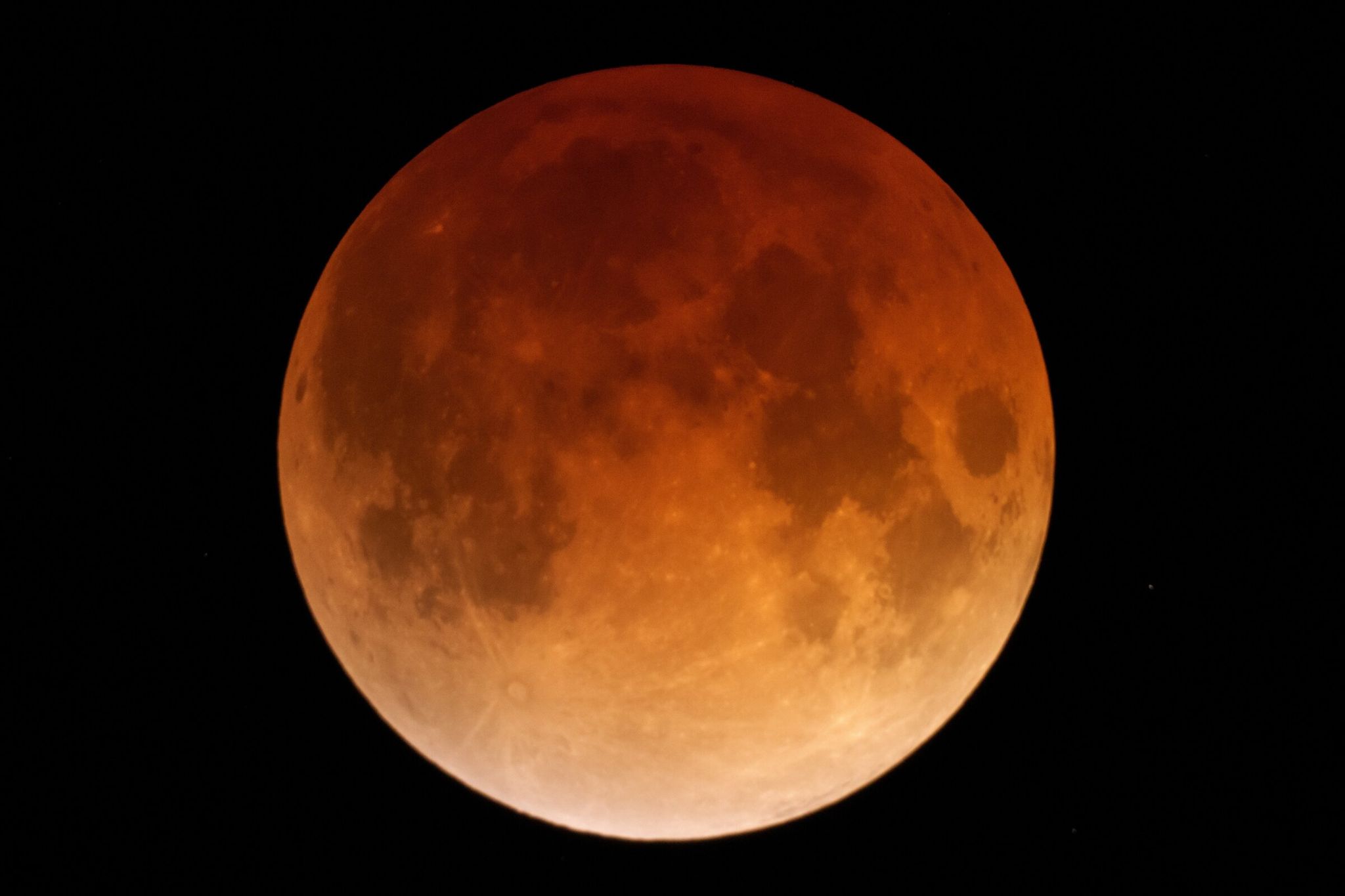 Full moon glows orange during the total phase of a lunar eclipse in the early morning hours Tuesday, March 3, 2026, near the town of Moscow, Idaho. When a full moon coincides with a total lunar eclipse, it is called a ‘blood moon.’ (Ted S. Warren / The Associated Press)