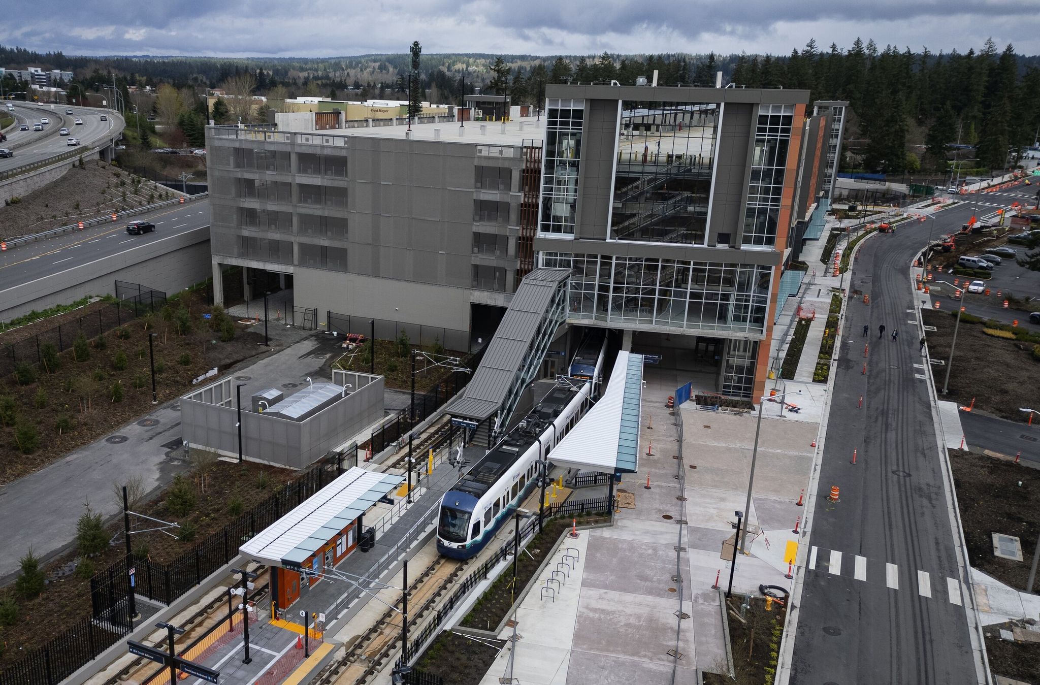 A light rail train on a test run last spring enters the 1,400-stall Marymoor Village Station parking garage before popping out on the other side and continuing to the 2 Line’s terminus in downtown Redmond. (Ken Lambert / The Seattle Times)