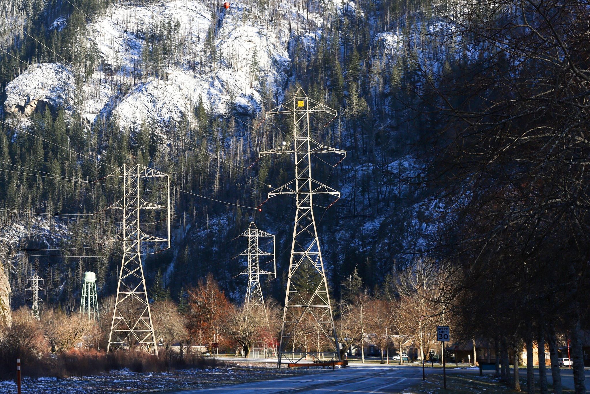 High-voltage transmission lines are shown along Highway 20 in Newhalem, Whatcom County, in the western foothills of the North Cascades. This past winter’s snowpack and earlier-than-normal melting season are cutting into Washington’s ability to generate hydropower, the largest source, by far, of electricity. (Karen Ducey / The Seattle Times, 2024)