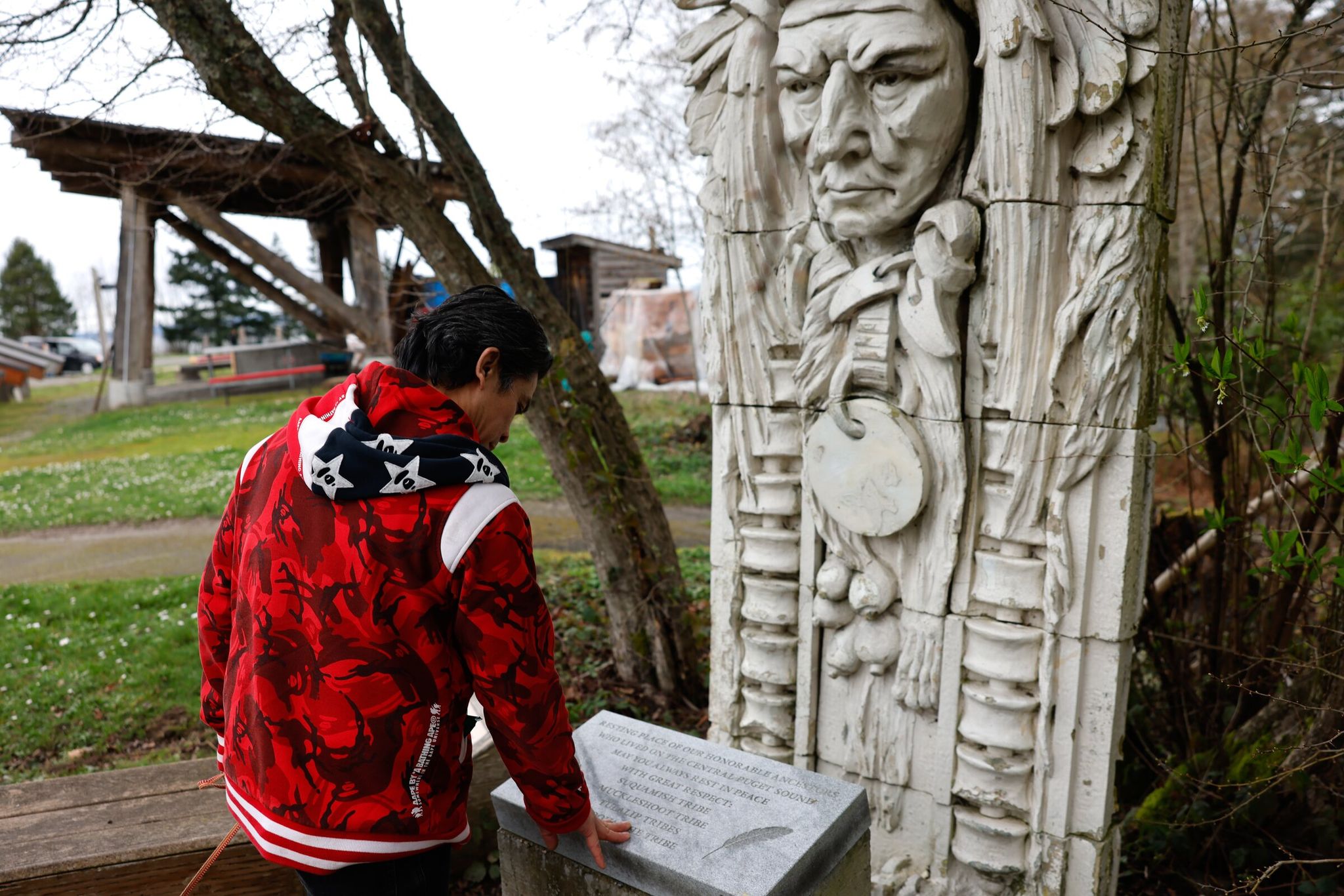 Bernie Whitebear’s nephew Marland Franco touches a memorial to his ancestors, including Whitebear, at the Daybreak Star Indian Cultural Center in Seattle on Saturday. The United Indians of All Tribes Foundation held an event remembering the 1970 Fort Lawton takeover. (Karen Ducey / The Seattle Times)
