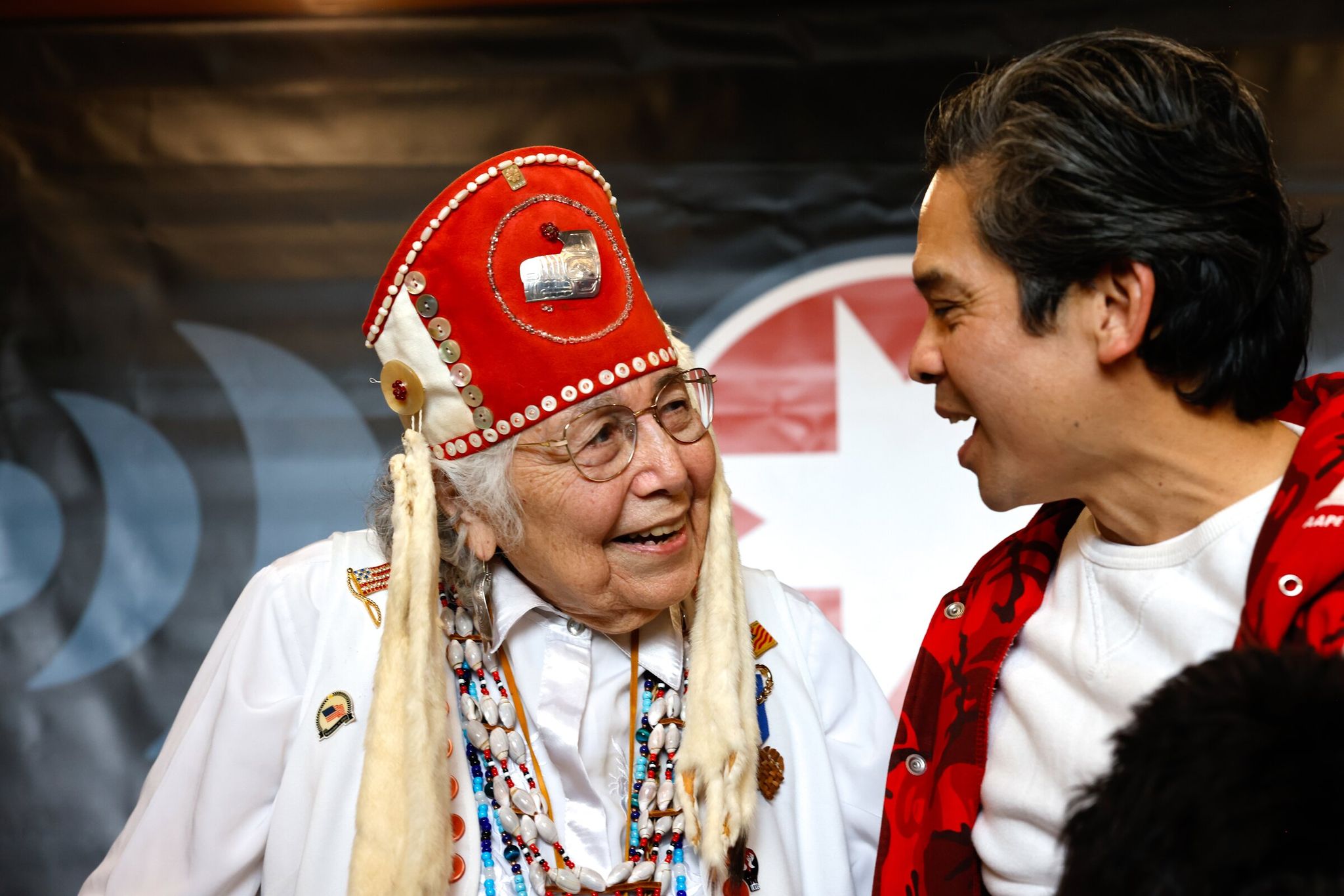 Marland Franco (right), nephew of Bernie Whitebear, tells Anna Haala (Tlingit) (left) how happy his mother, Laura Wong Whitebear, would have been to see them both together in a photo at the United Indians of All Tribes Foundation event commemorating the 1970 Fort Lawton takeover at the Daybreak Star Indian Cultural Center in Seattle on Saturday. (Karen Ducey / The Seattle Times)